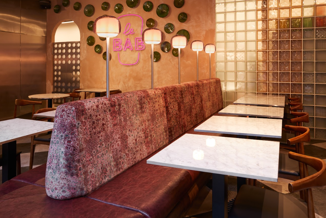 Modern dining area with stylish booths at The Lounge & Kebab Queen, ideal for events.