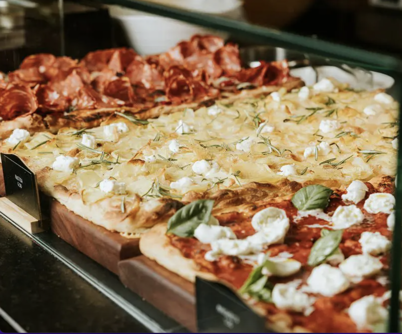 Variety of gourmet pizzas at Luci venue for networking events and casual gatherings.