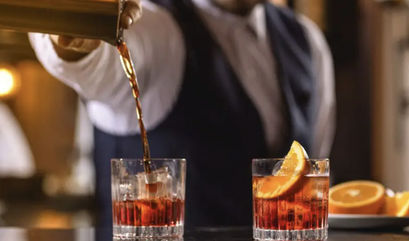 Bartender crafting cocktails in elegant venue, perfect for upscale events and gatherings.