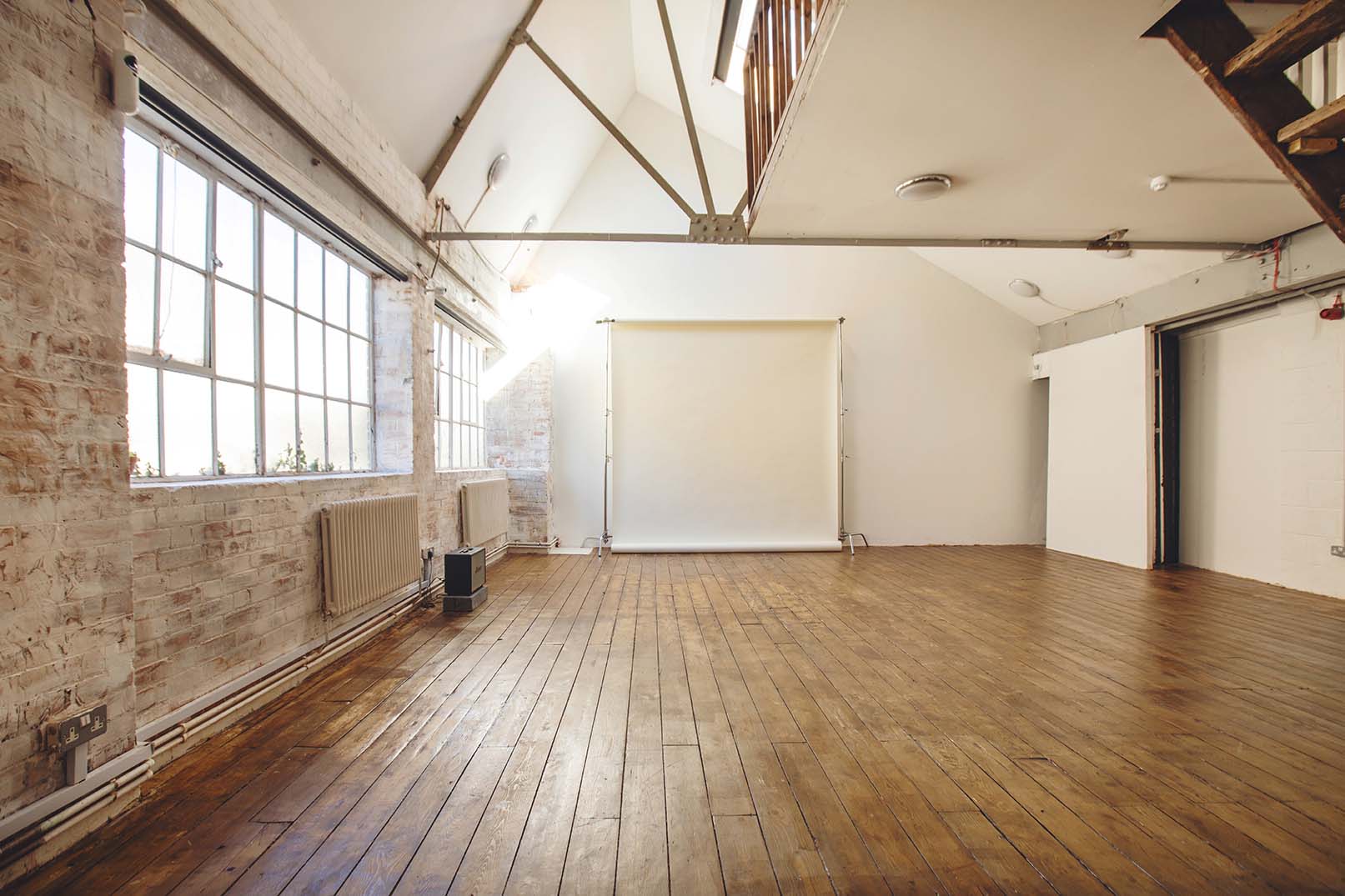 Industrial-chic studio with natural light for creative workshops and product launches.