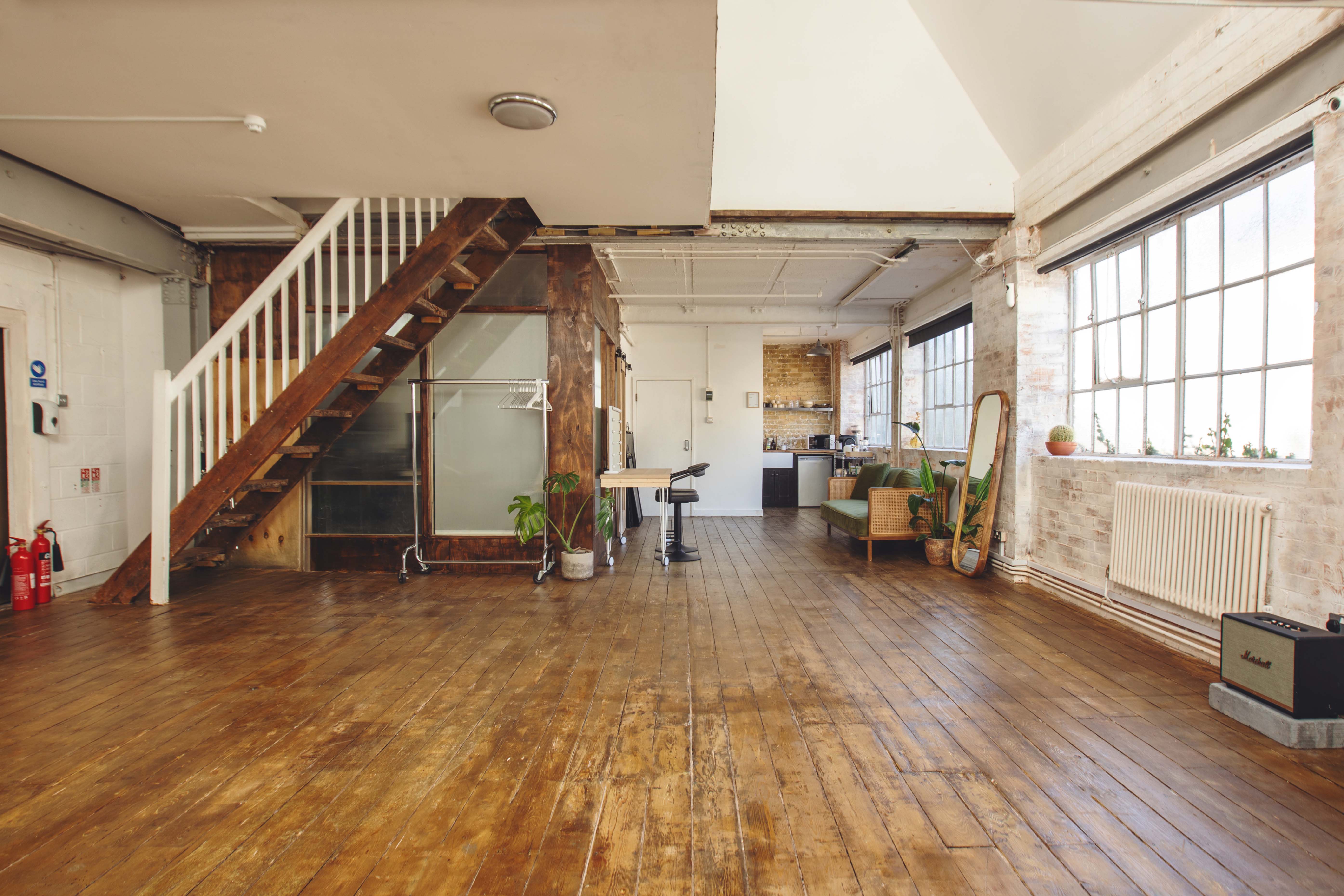 Industrial-chic loft studio with natural light, perfect for creative workshops and pop-up events.