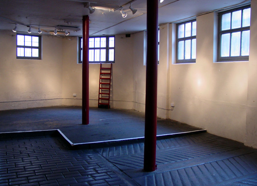 Industrial venue at The Horse Hospital with pillars for pop-up gallery and event showcase.