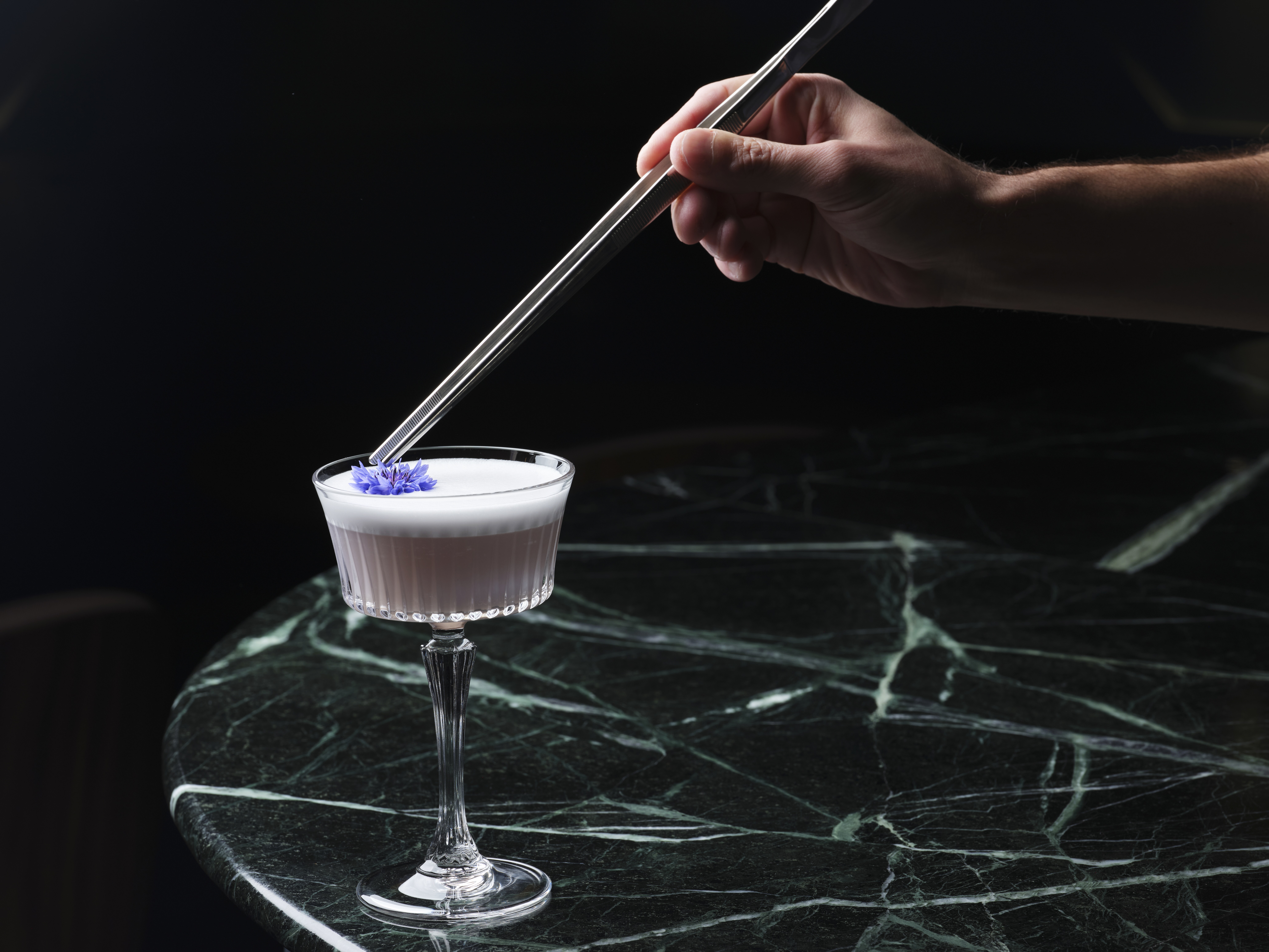 Meticulously crafted cocktail with edible flowers at Bechstein Hall's upscale restaurant.