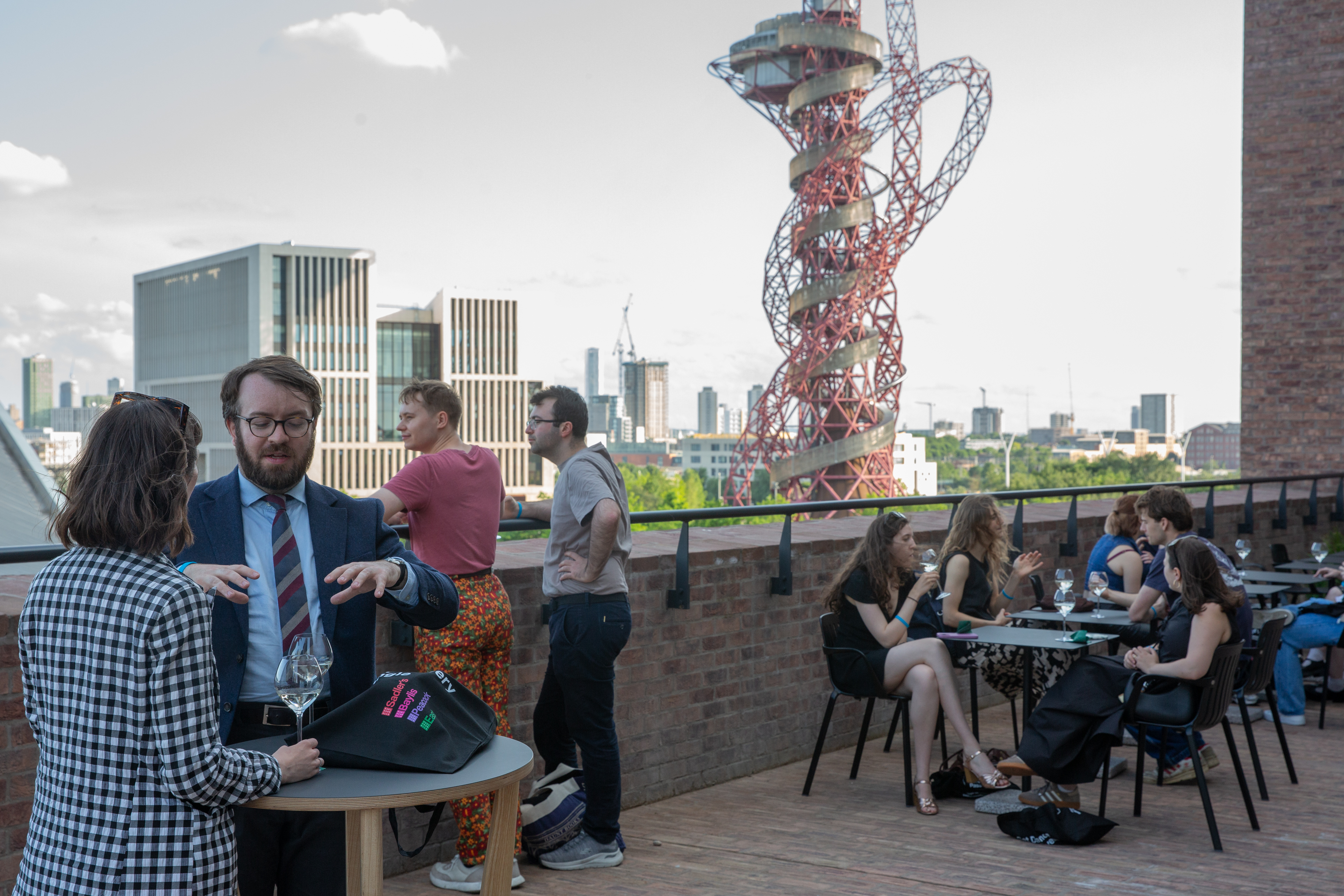 Vibrant networking event on rooftop terrace at Martha Graham Studio, blending business and leisure.