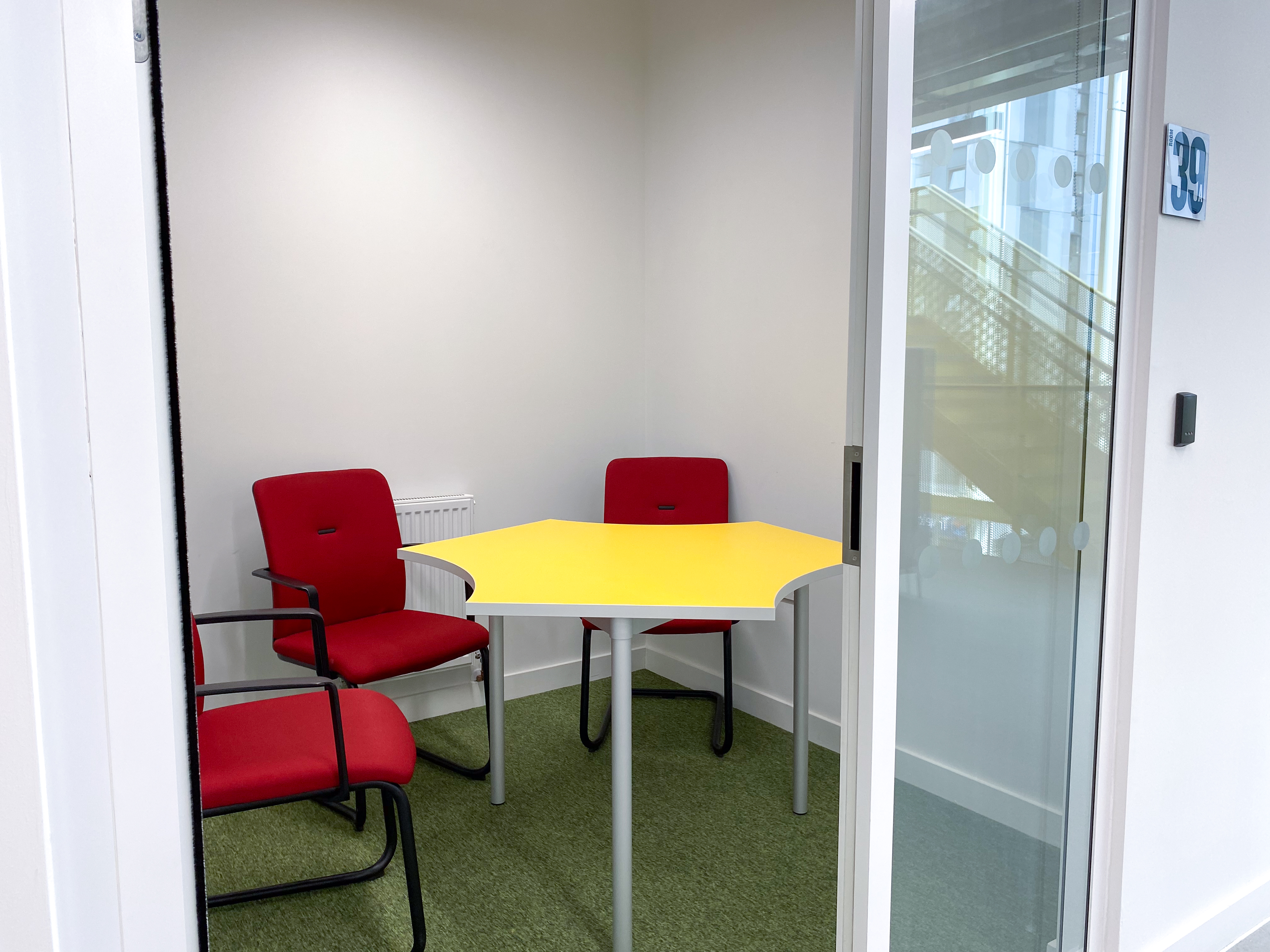 Bright yellow table in Consultation Room 39a/39b/39c for meetings and brainstorming.