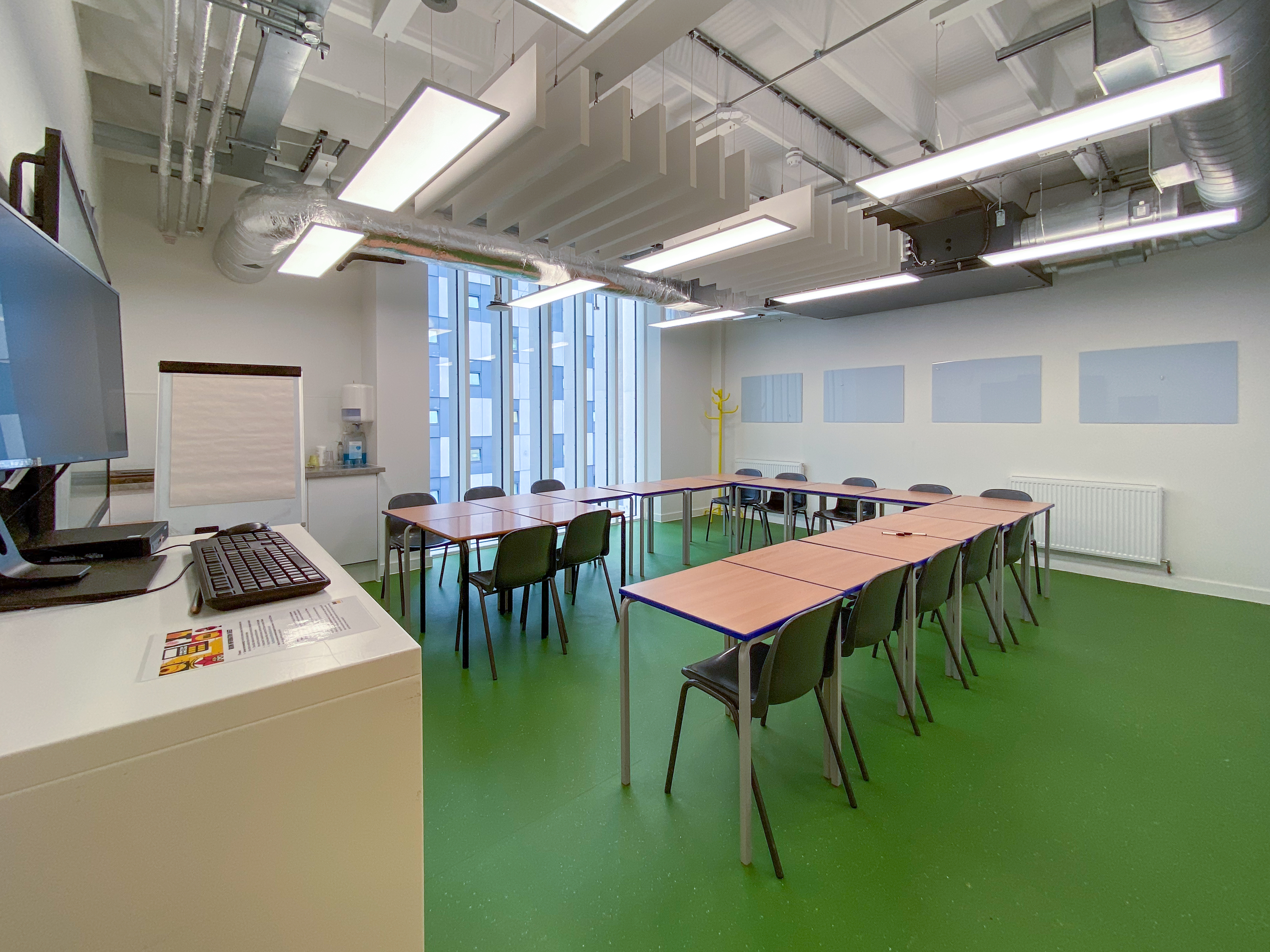 Well-lit meeting room with U-shaped seating for collaborative sessions at Mary Ward Centre.