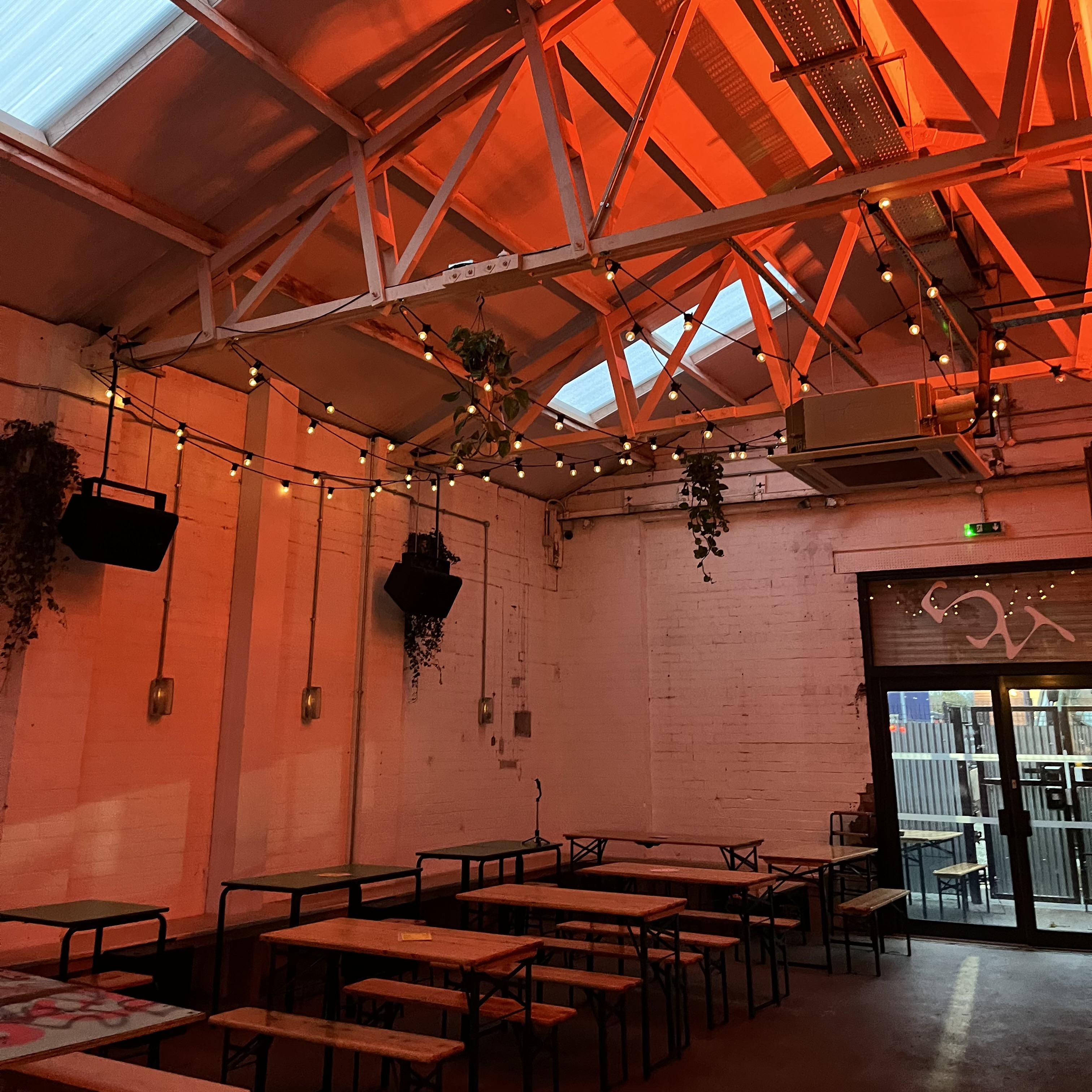 Industrial-chic event space with string lighting for pop-up activations and receptions.