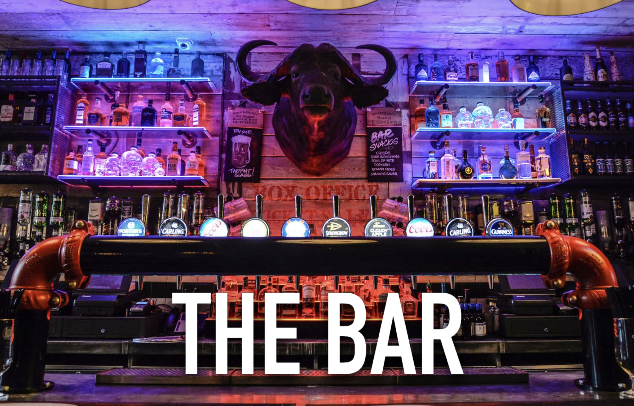 Vibrant bar with illuminated spirits, perfect for networking events and social gatherings.