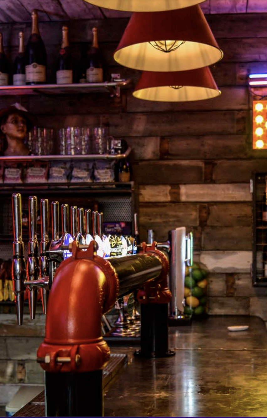 Polished bar area with draft beer taps for networking events at Up The Creek.