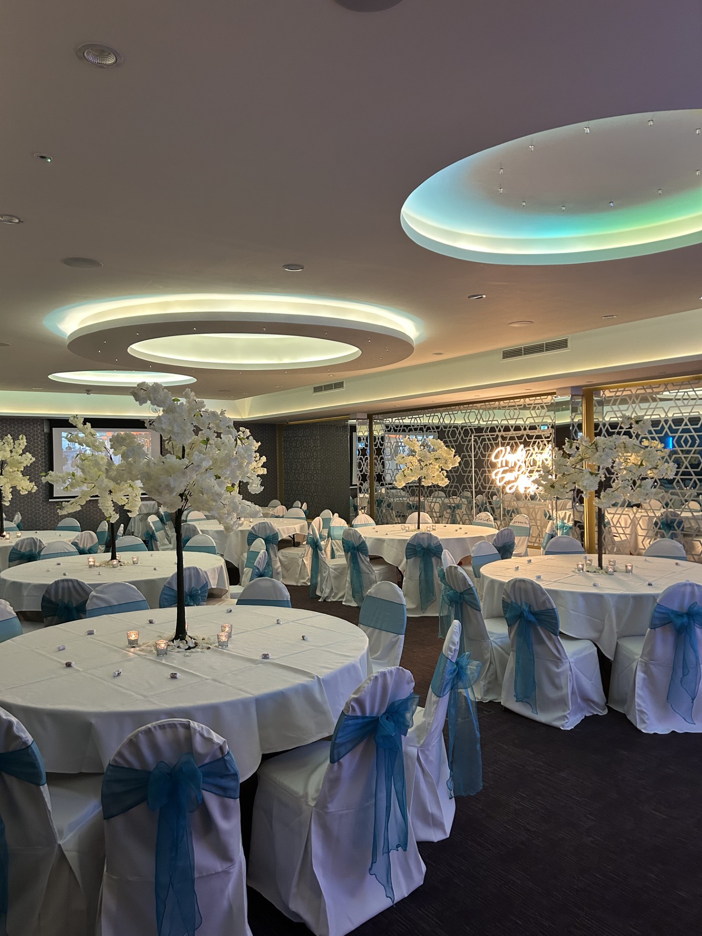 Elegant event space at The York, featuring round tables and floral centerpieces for weddings.