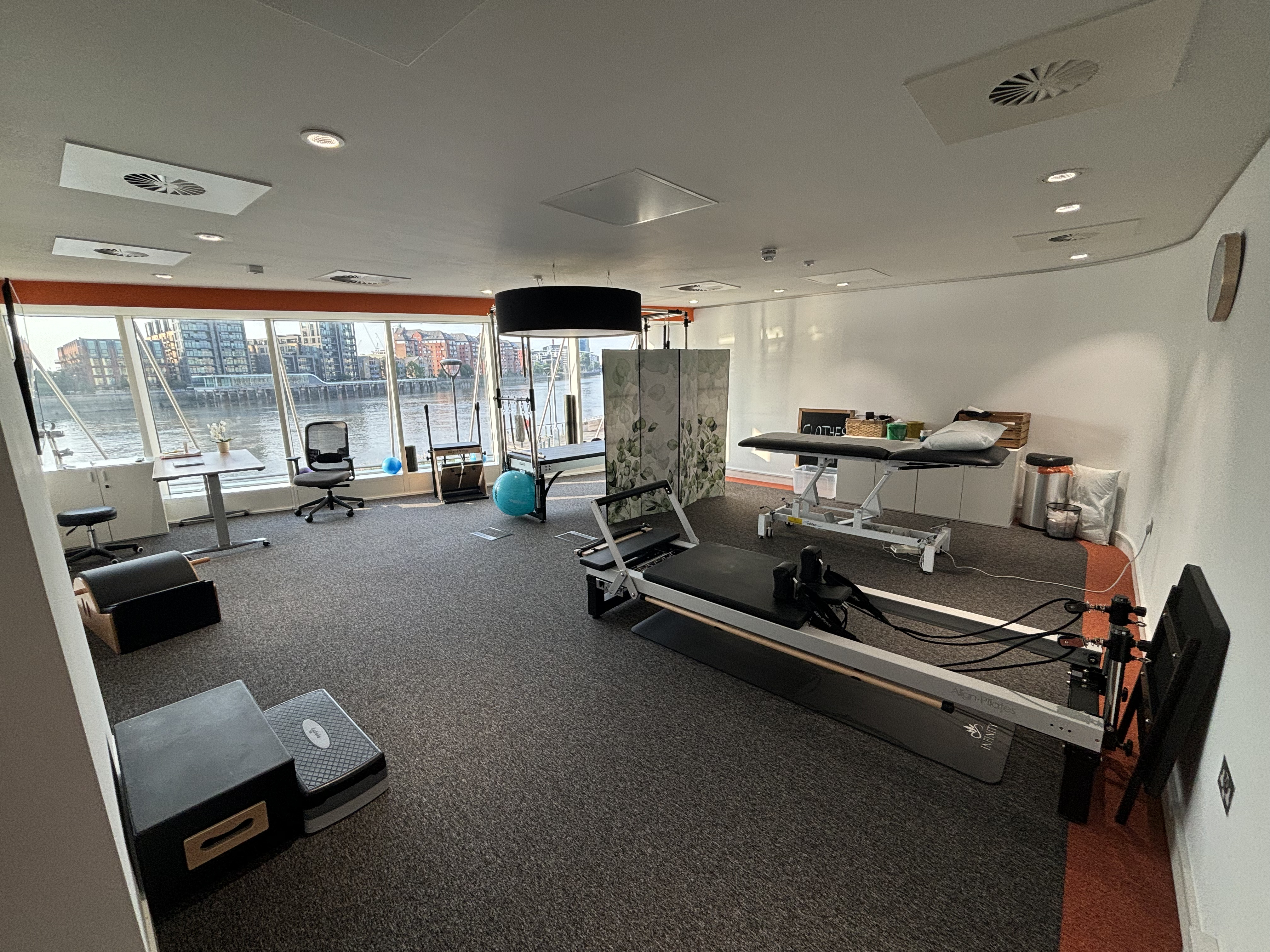 Elite Physios wellness room with floor-to-ceiling river views for corporate retreat and mindfulness.