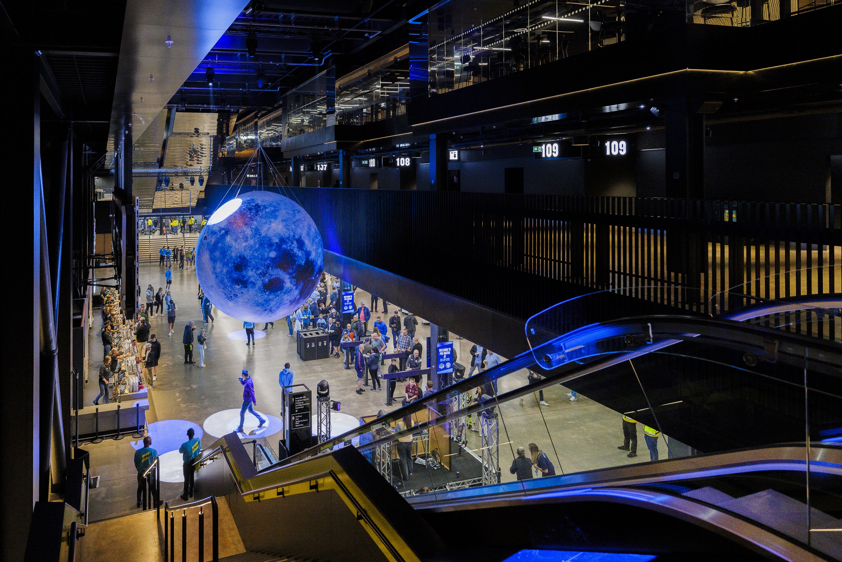 Vertu Place at Co-op Live: modern event space with illuminated moon, perfect for exhibitions.