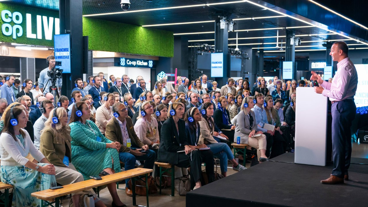 "Vertu Place Co-op Live event with engaged audience in headphones for silent conference"