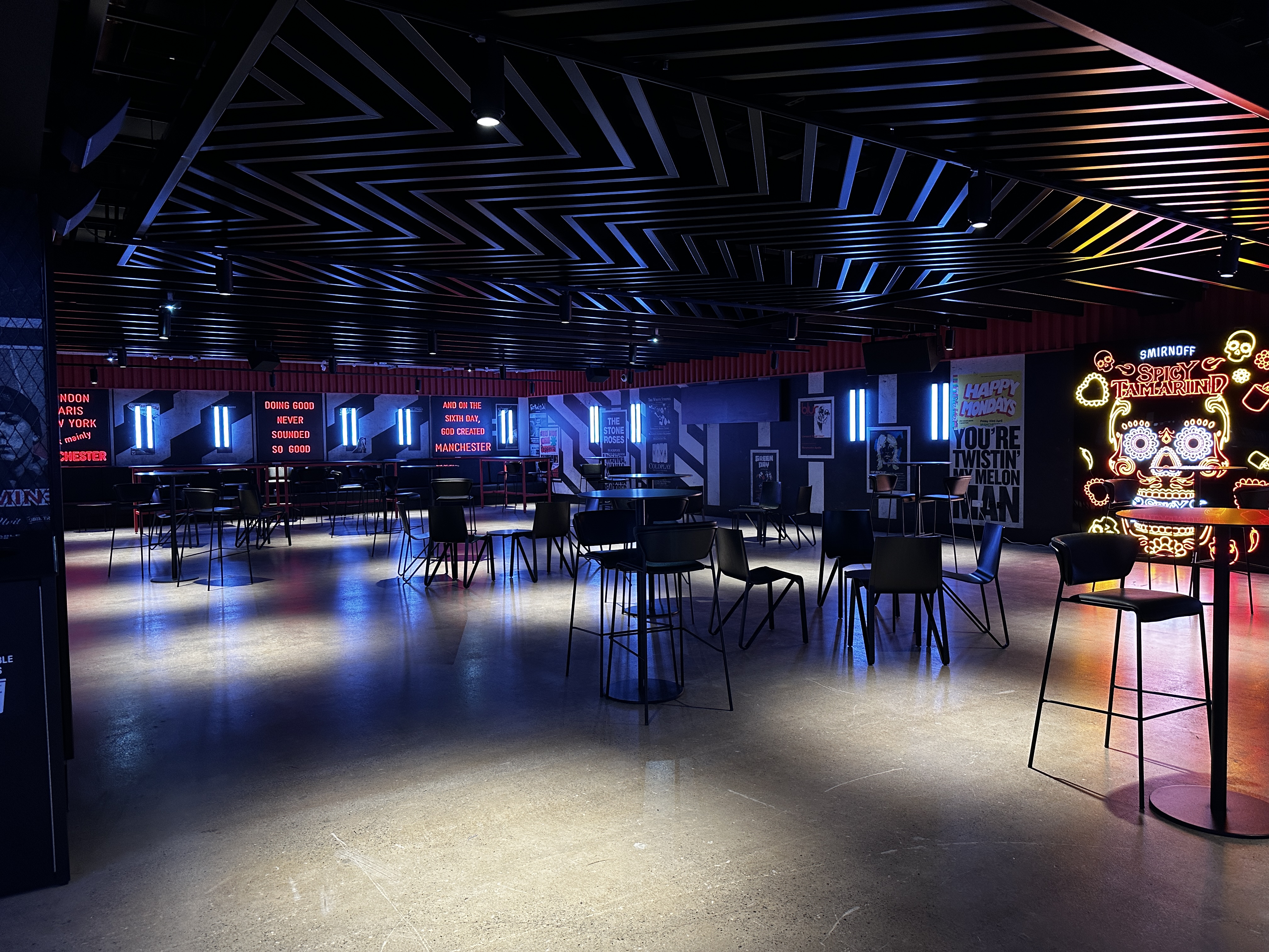Modern event space at Co-op Live, featuring a striking striped ceiling for networking events.