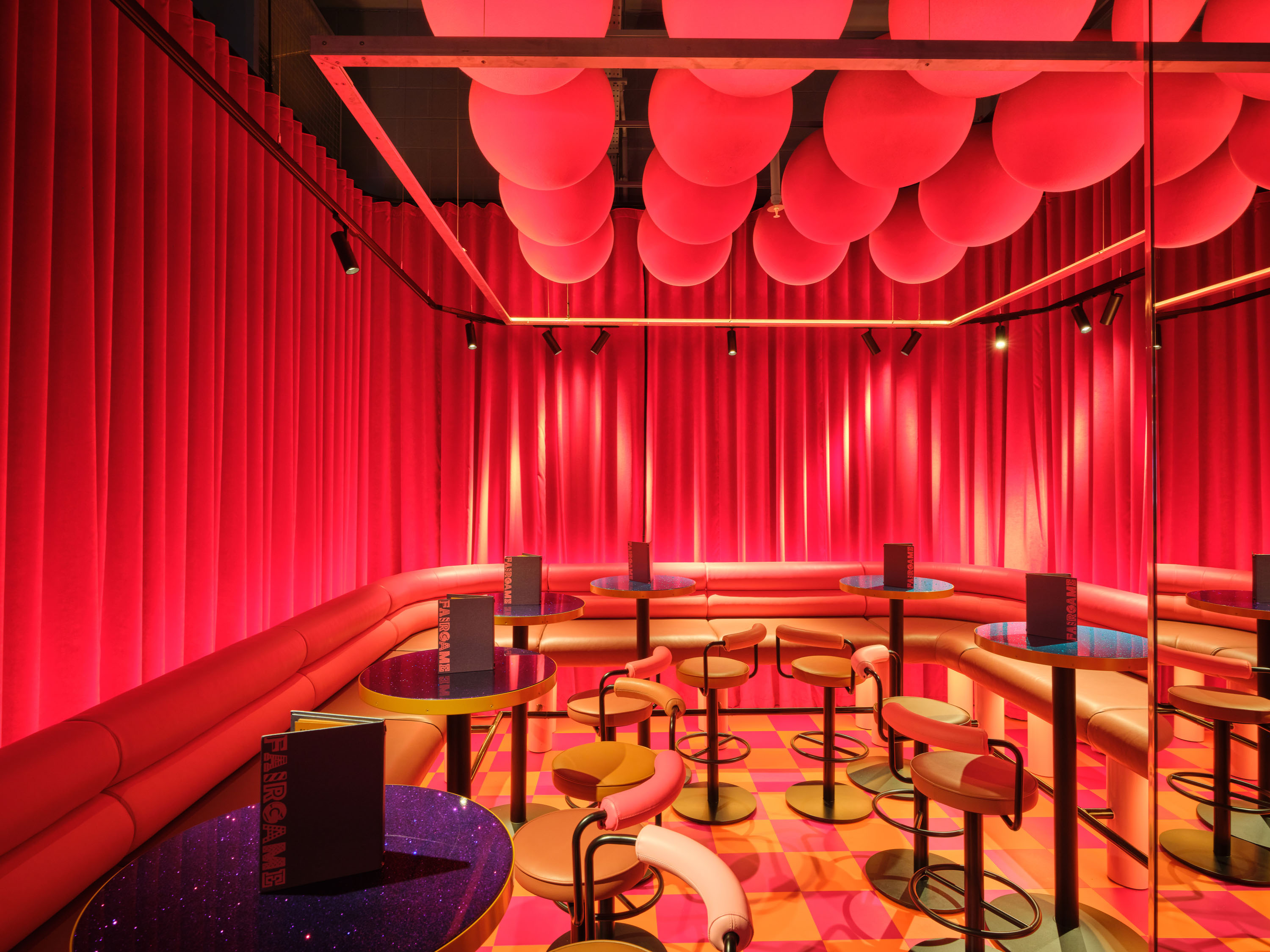Vibrant Fun House event space with bold red hues, ideal for networking and gatherings.