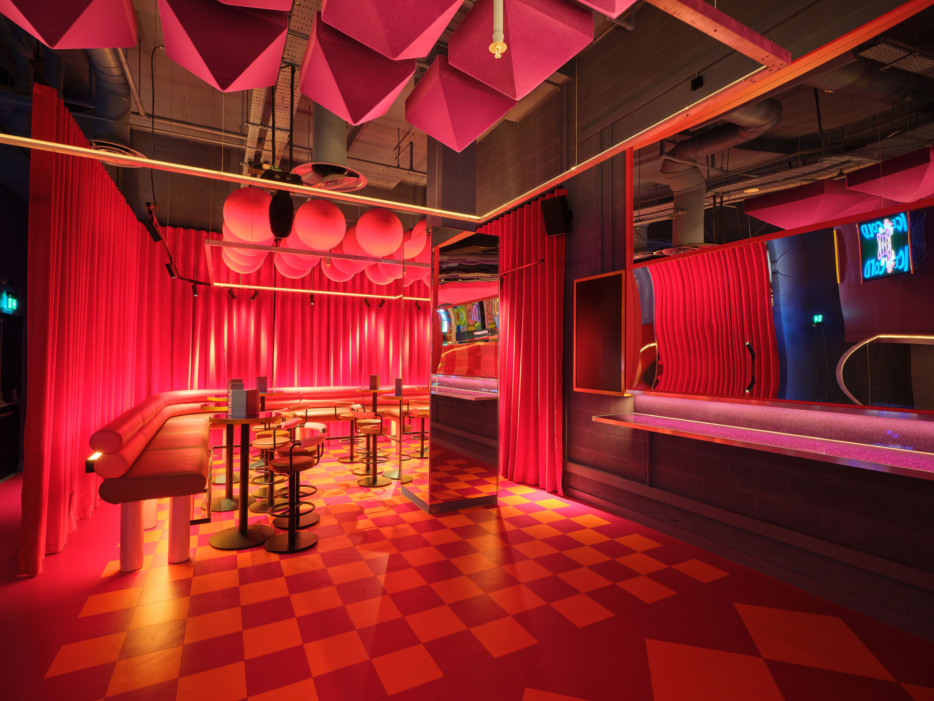 Vibrant Fun House event space with bold pink decor for networking and social gatherings.