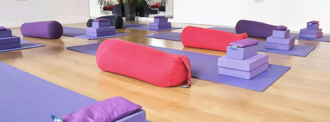 Yoga studio wellness breakout space with mats and bolsters for experiential events.