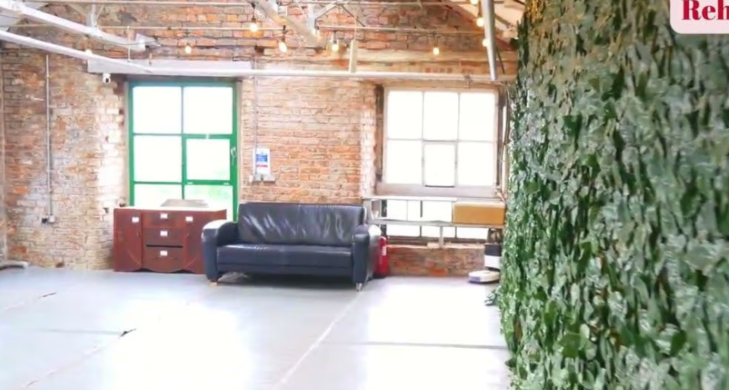 Industrial-chic venue at Play With Fire Studios with living wall for creative workshops, networking.