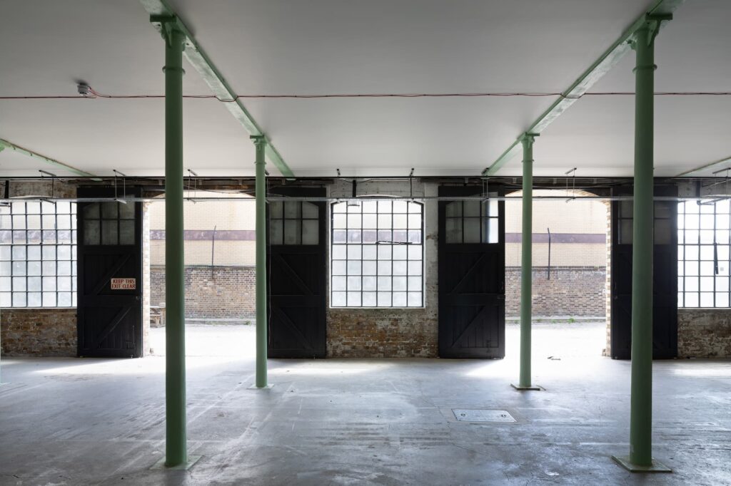 Industrial pop-up space at The Bottle Factory featuring structural pillars for experiential events.