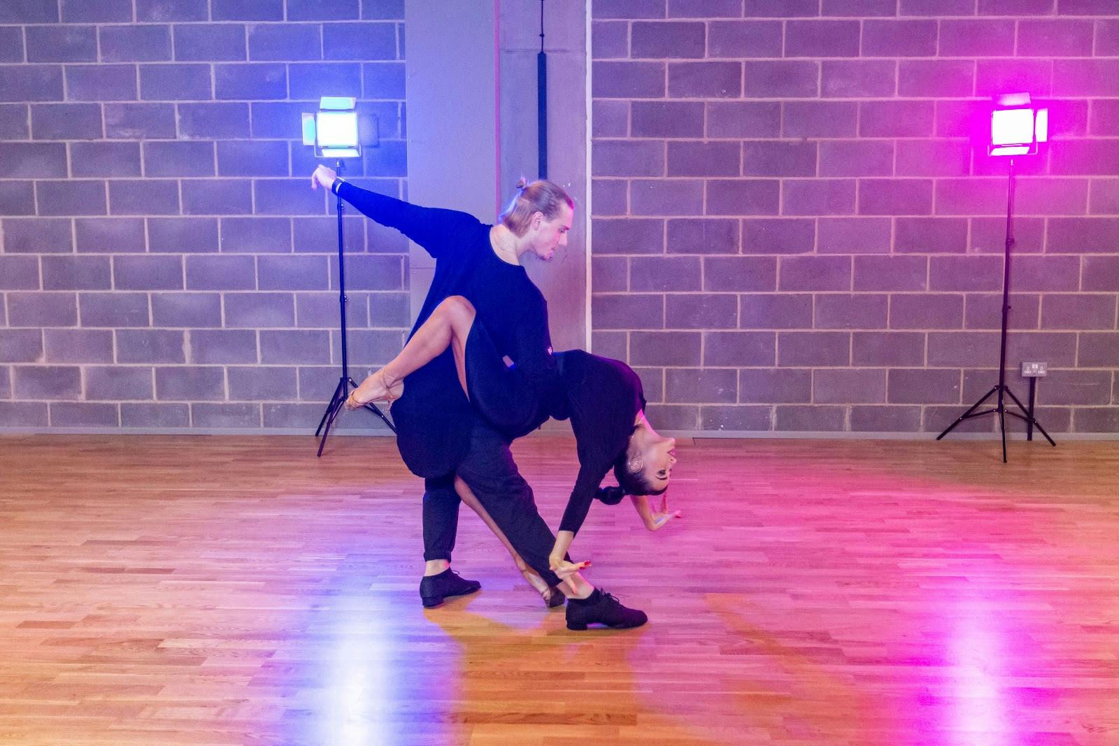 Industrial dance studio with dramatic lighting for rehearsal and performance event space rental.