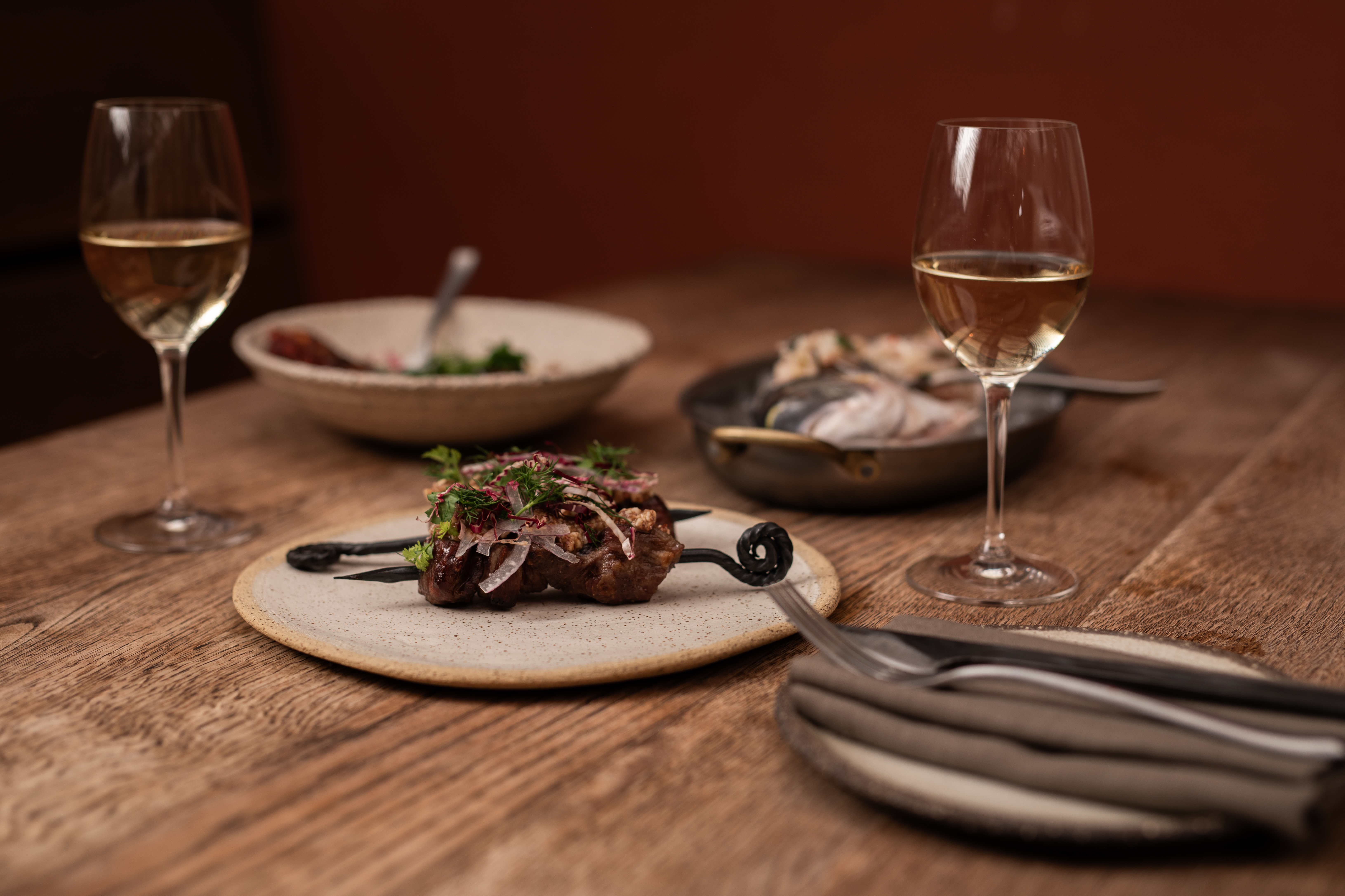 Elegant dining table at Pyro Restaurant with gourmet dishes for upscale events.