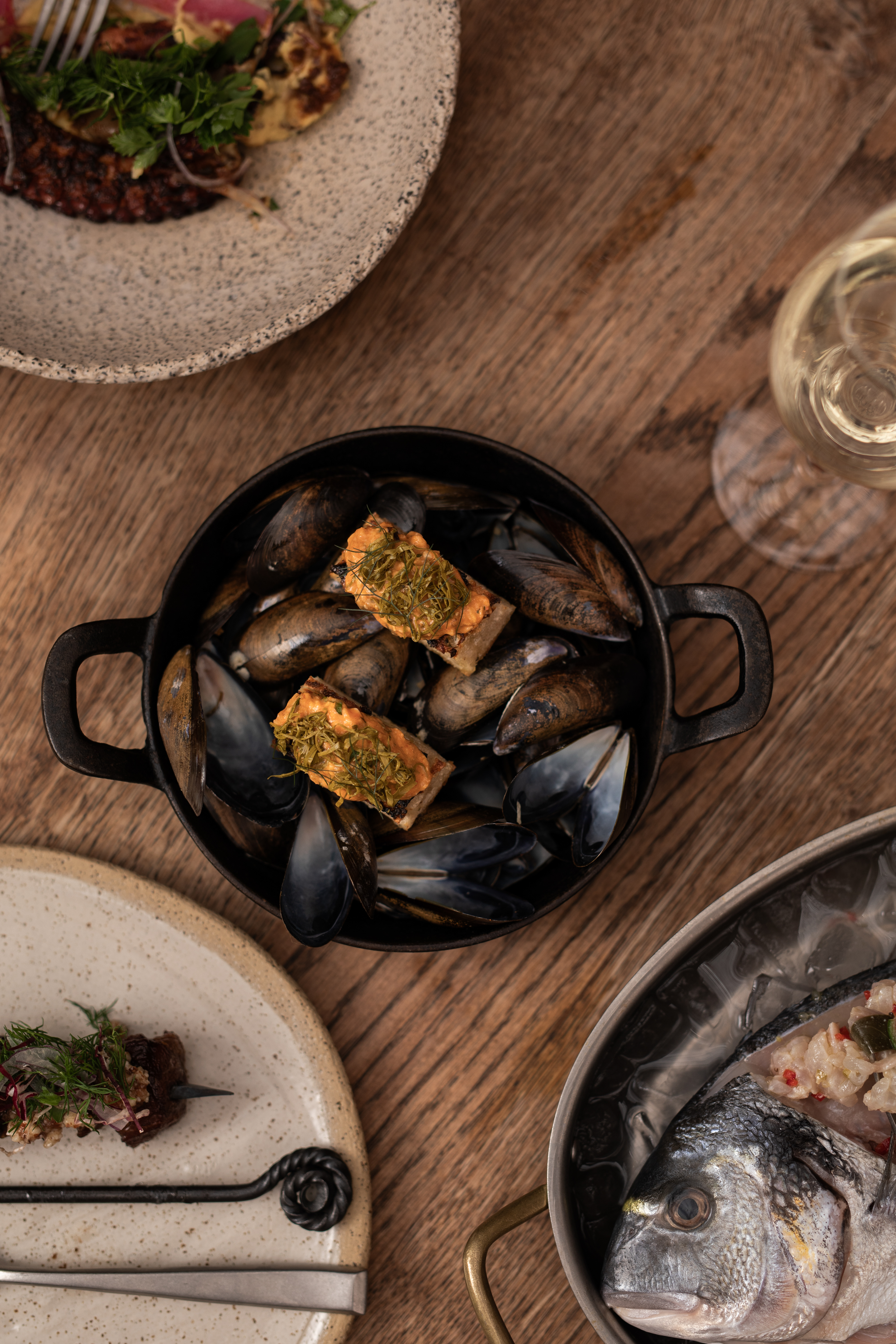 Mussels in rustic pot at Pyro Restaurant, perfect for upscale dining and catered events.