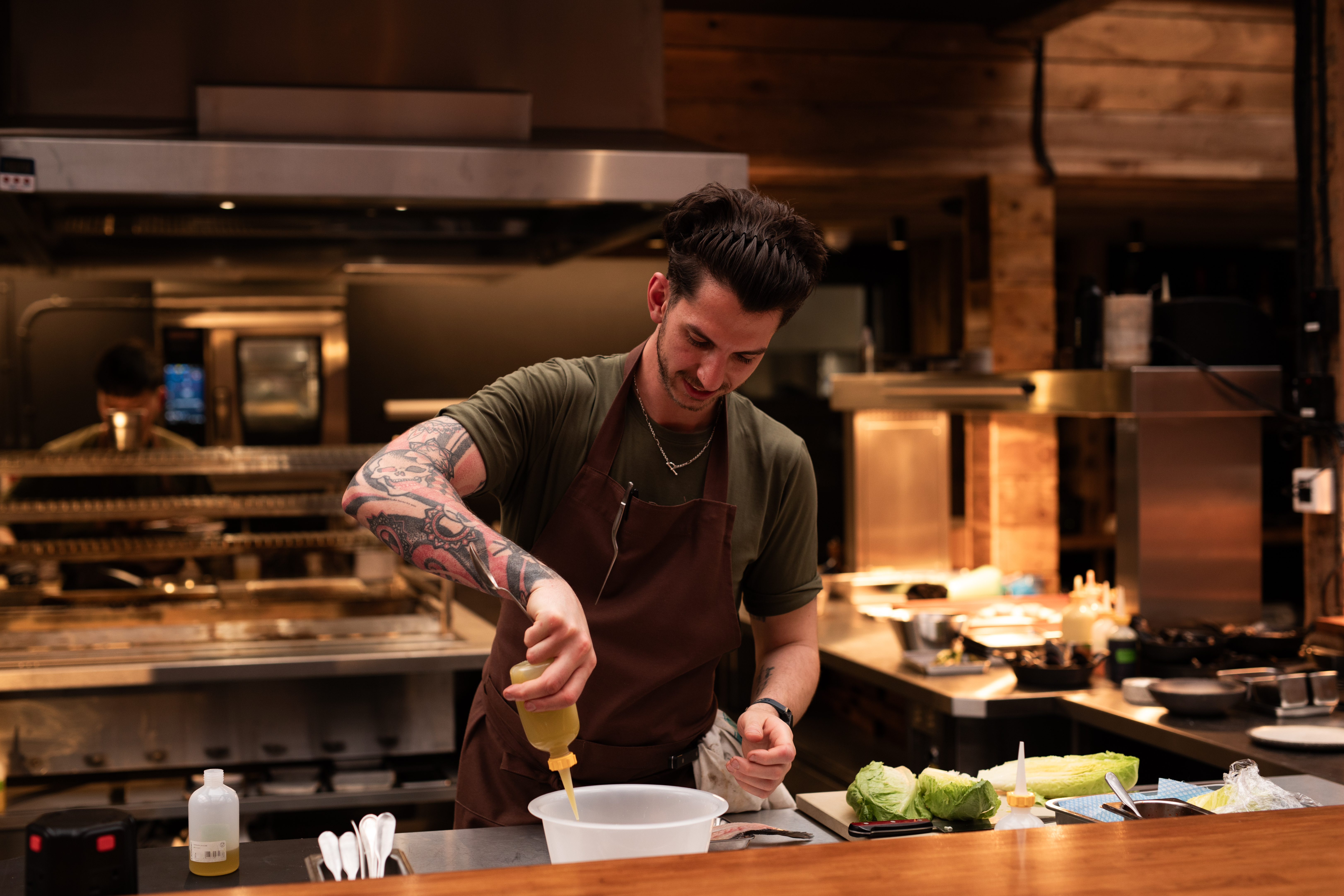 Chef preparing ingredients in Pyro Restaurant, ideal for team-building culinary events.