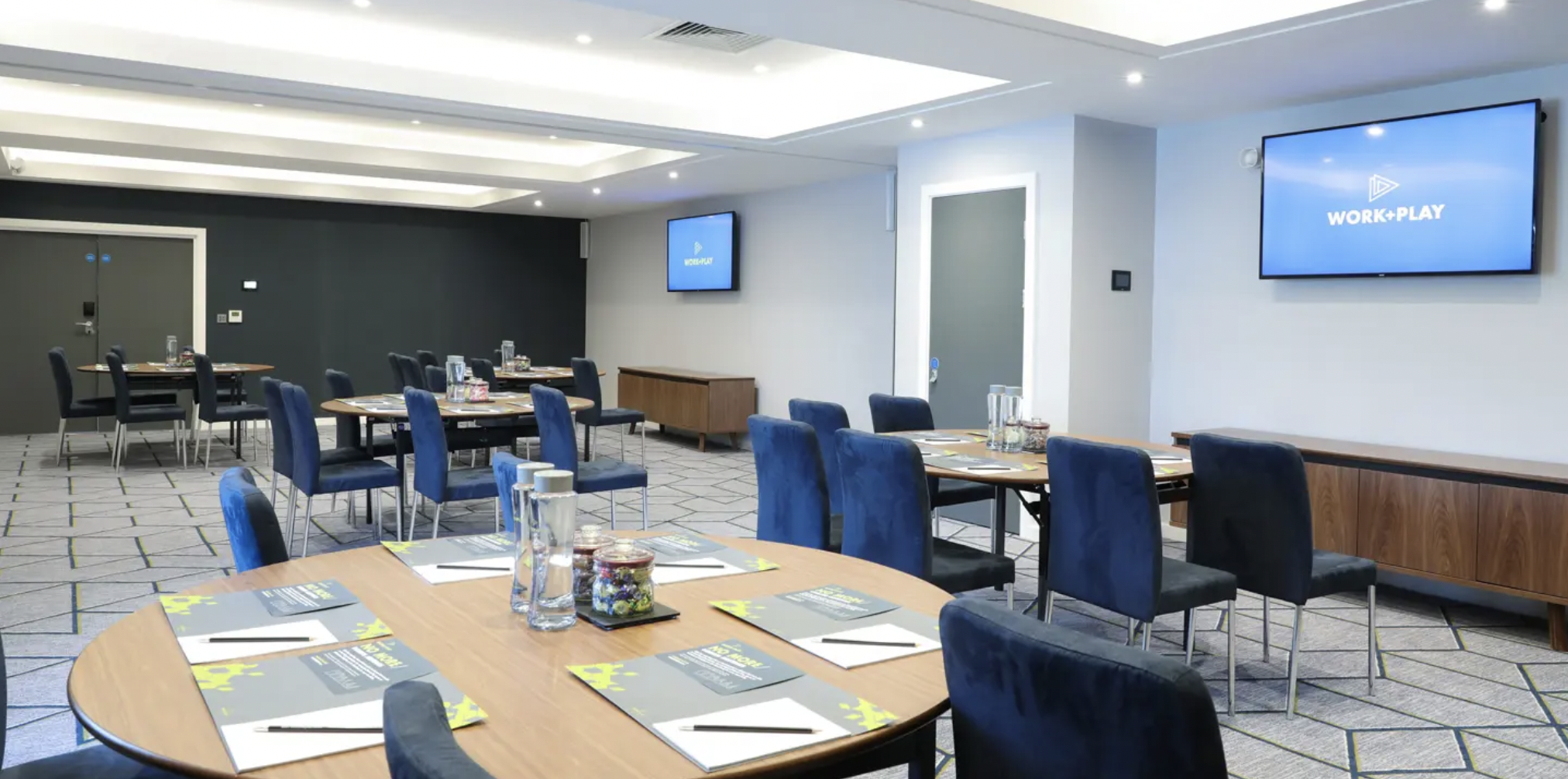 Modern breakout space at Malmaison Brighton with round tables for corporate workshops and meetings.