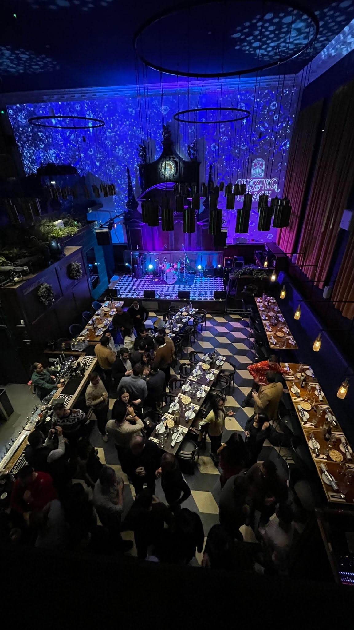 Vibrant Mezzanine event space with stage, ideal for corporate gatherings and celebrations.