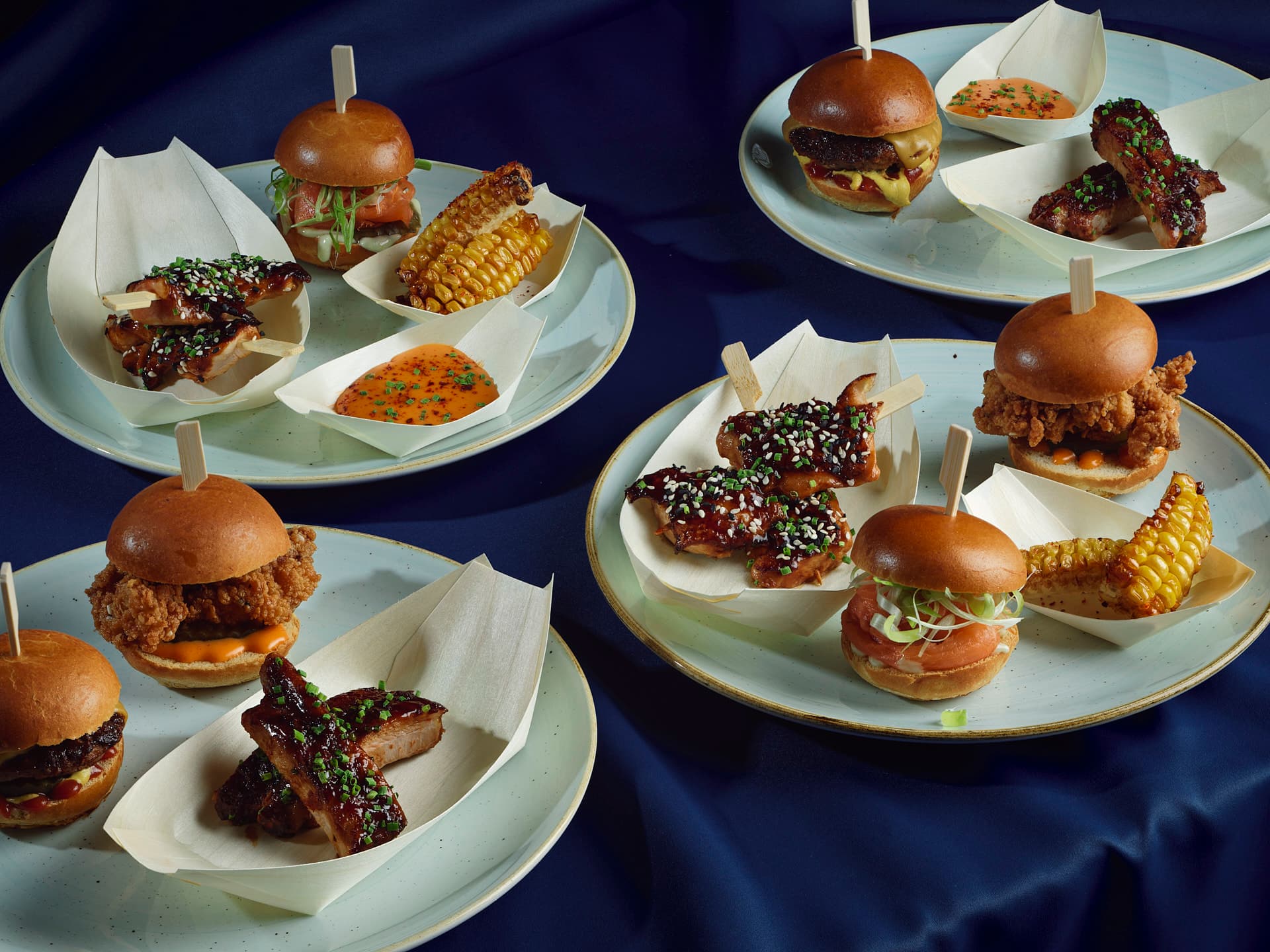 Gourmet sliders and appetizers on elegant plates for upscale events and networking.