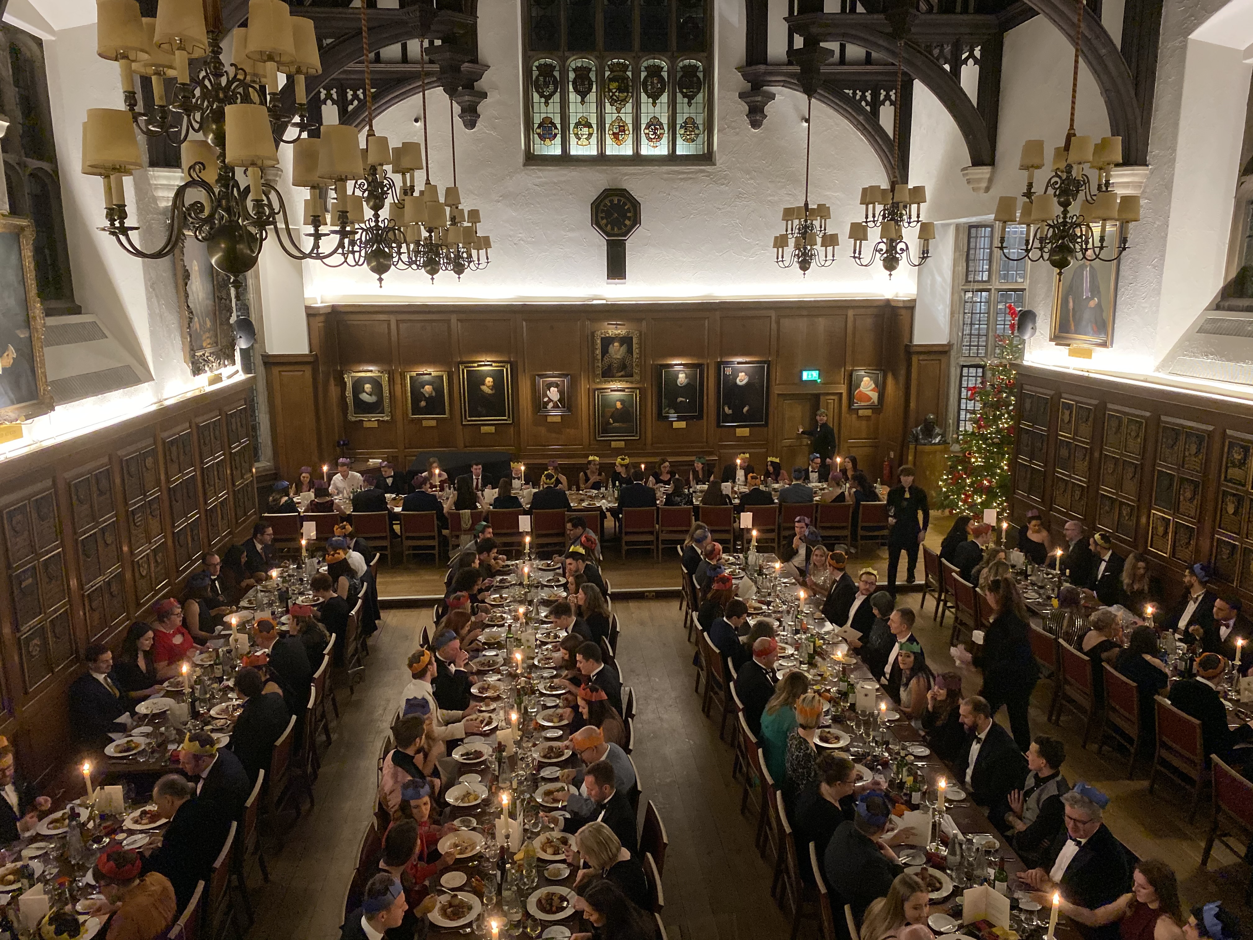 Christmas party in a historic banquet hall with elegant decor and festive atmosphere.