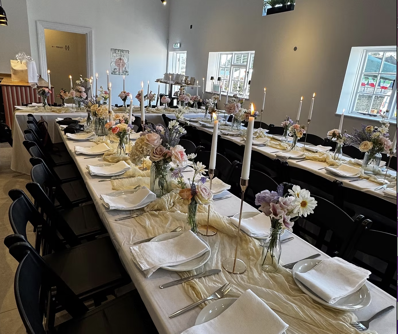Sewardstone Park Suite banquet layout with floral decor for weddings and corporate dinners.
