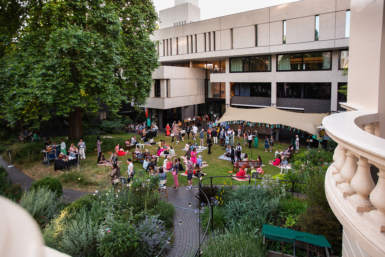 Vibrant outdoor event at RCP London with lush greenery, ideal for networking and gatherings.