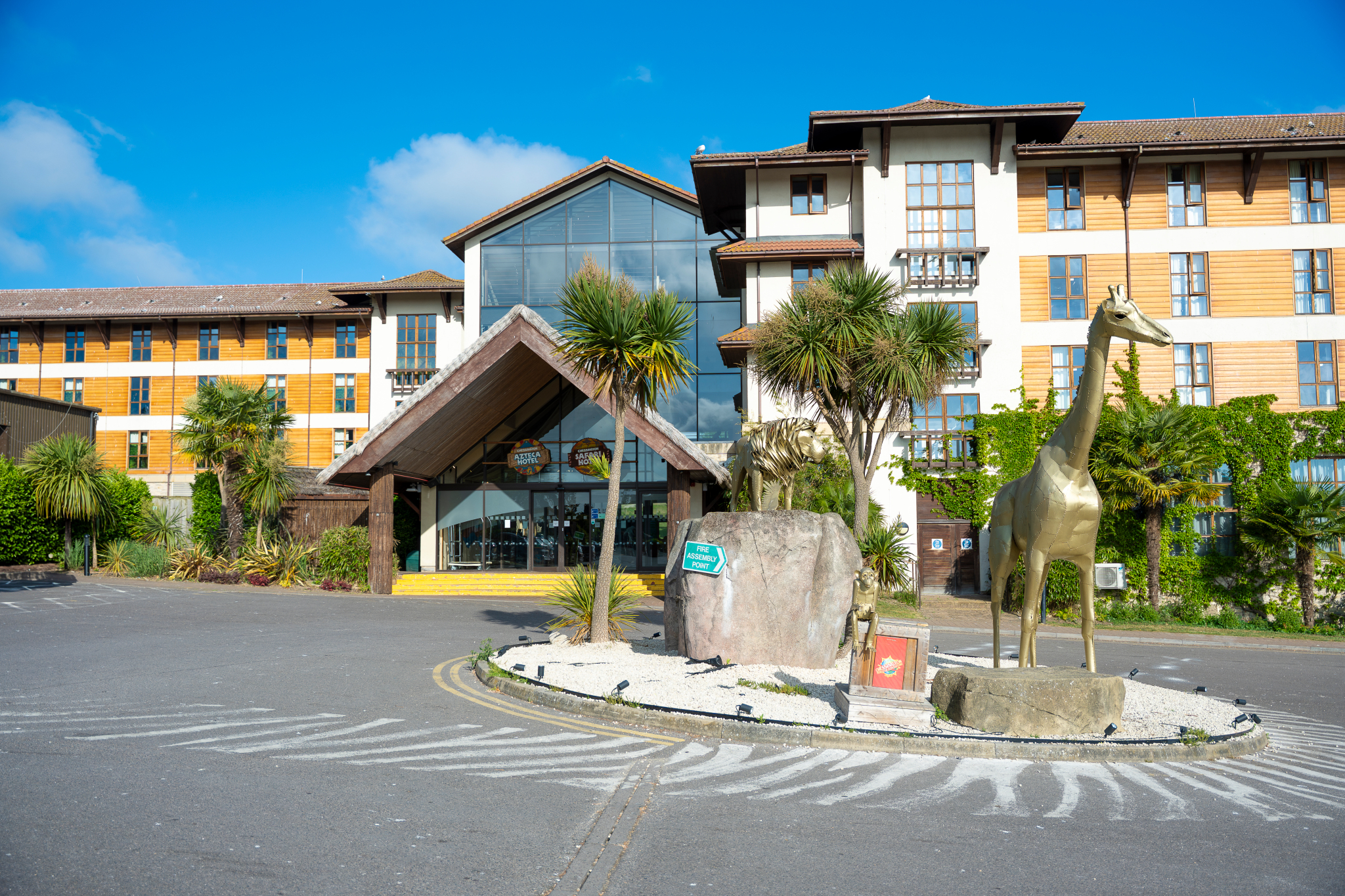 Modern hotel entrance at Chessington World of Adventures with golden giraffe statue, ideal for events.