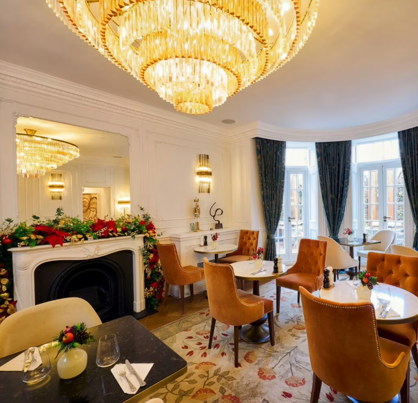 Chesham Hotel Belgravia lounge with plush orange chairs, ideal for upscale gatherings and meetings.