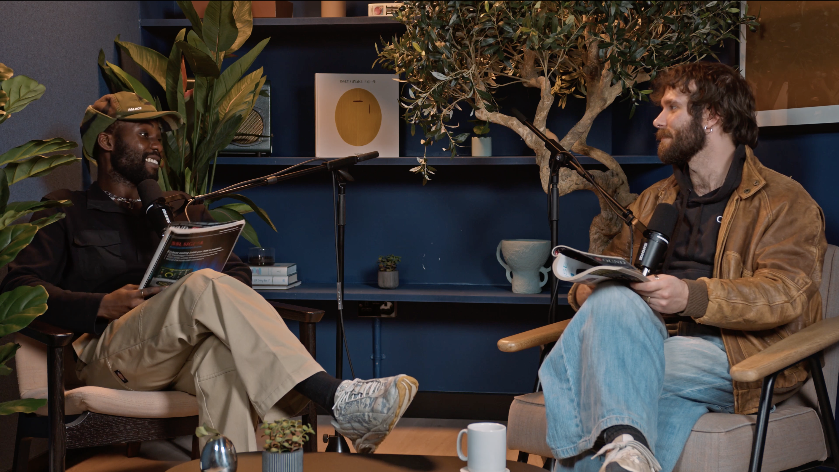 Intimate podcast studio with greenery, ideal for panel discussions and audience engagement.