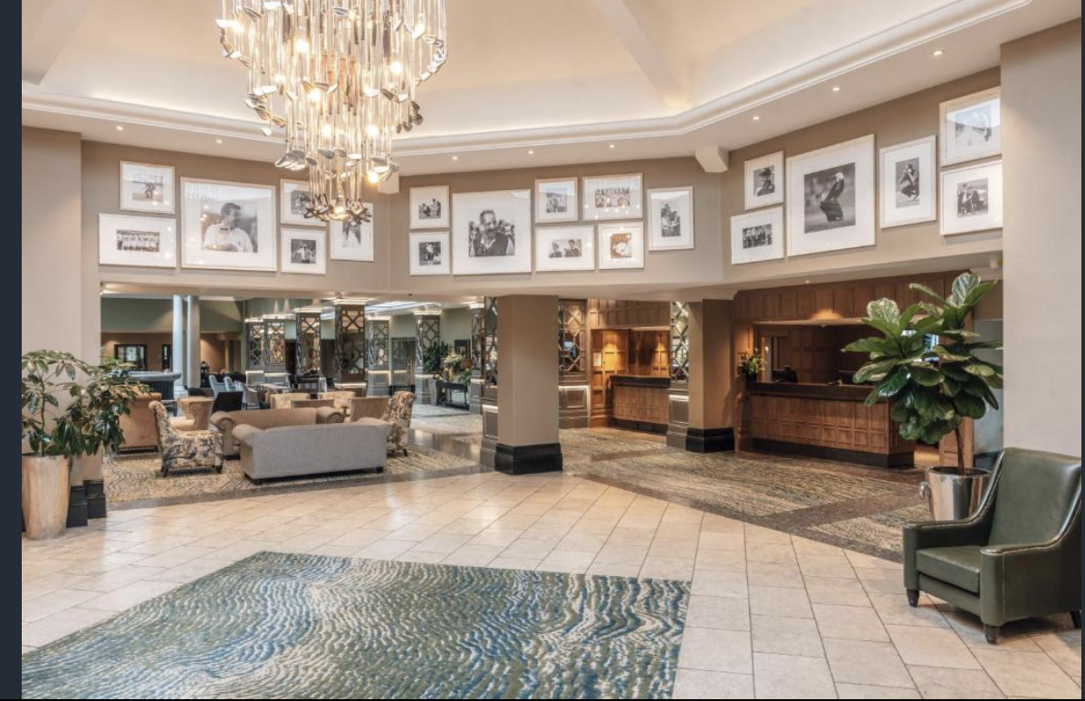 Elegant lobby of The Masters Suite at The Belfry for events, featuring a stylish chandelier.