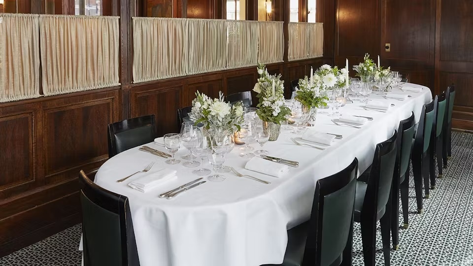 Private dining setup in The Delaunay with floral centerpieces for boardroom dinners or celebrations.