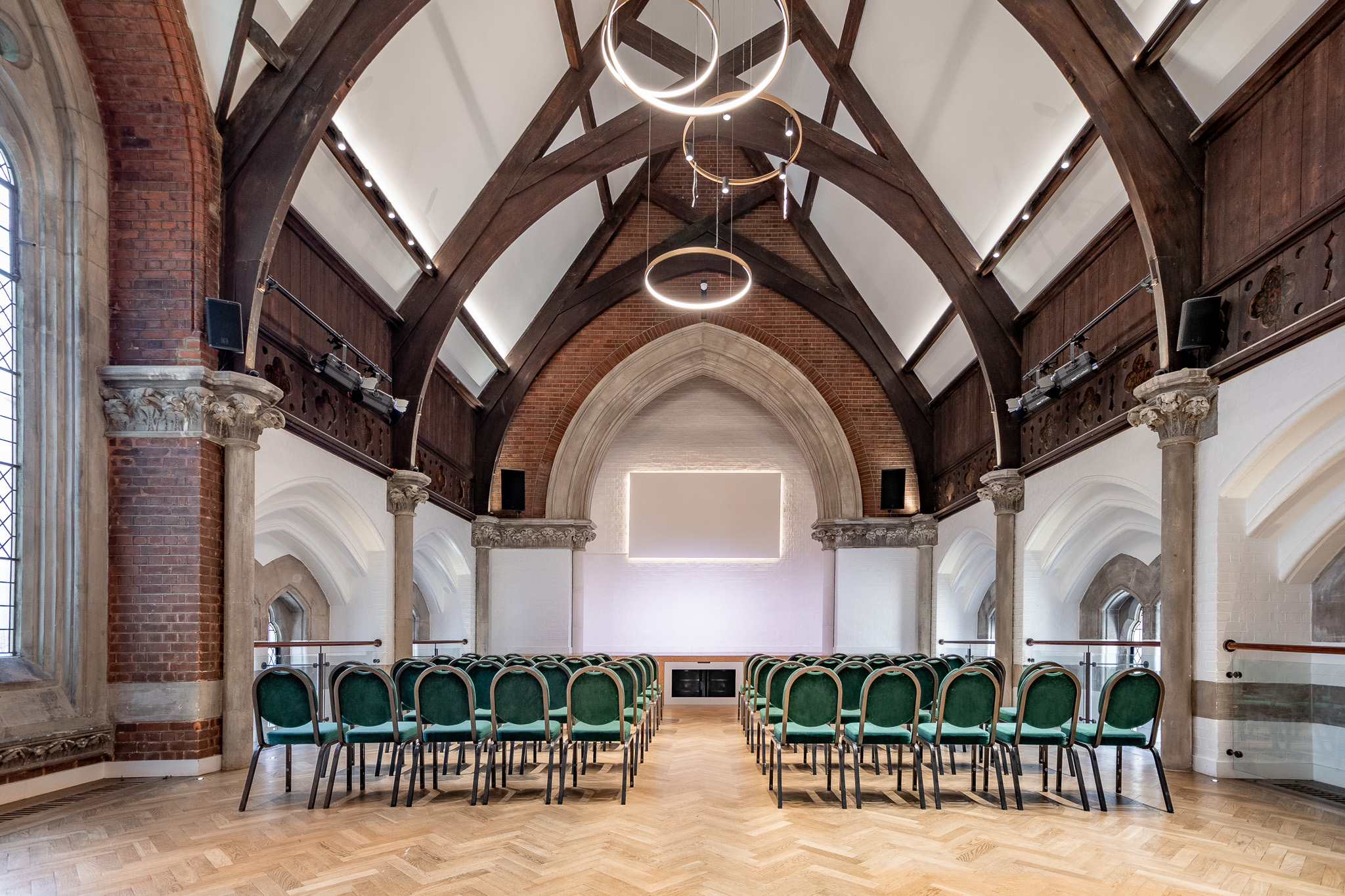 Historic Upper Hall venue with vaulted ceilings for professional presentations and ceremonies.