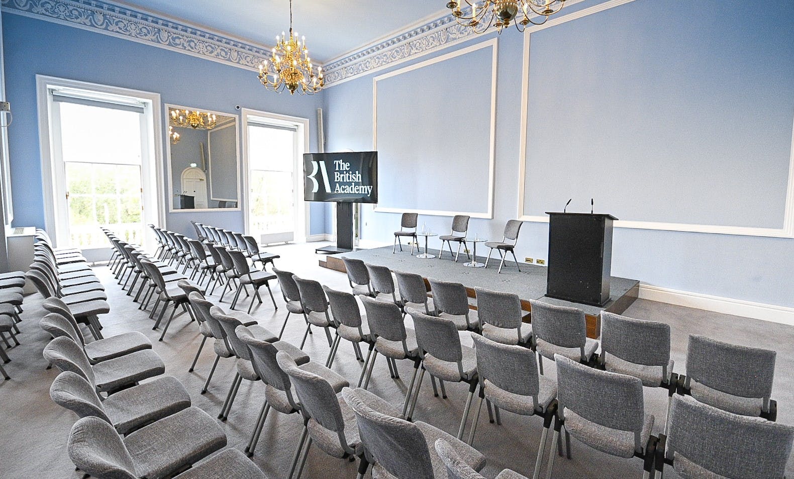 Neoclassical event space with theater-style seating for corporate conferences and seminars.