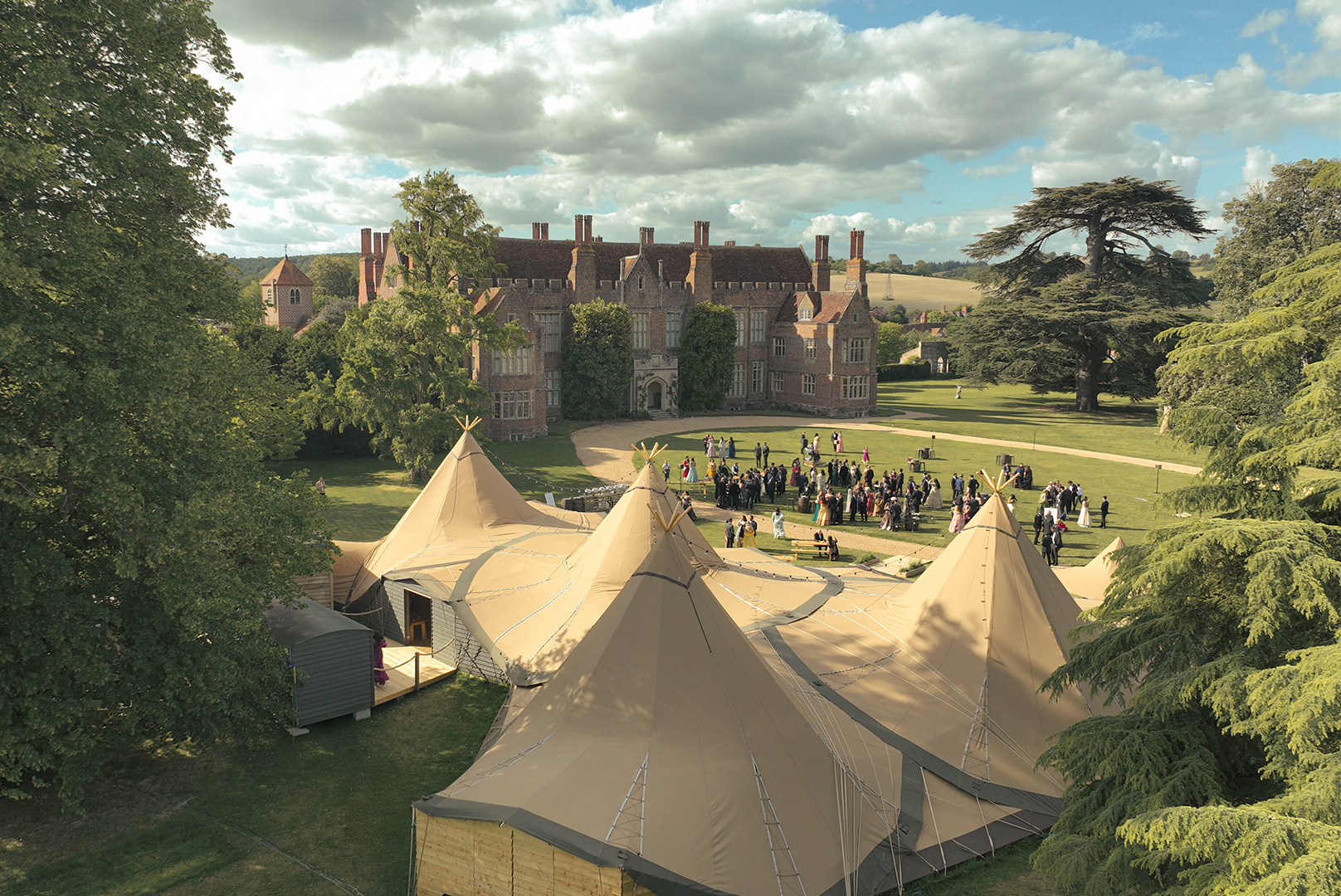 Multi-peak tipi venue at historic estate for outdoor weddings and corporate events.