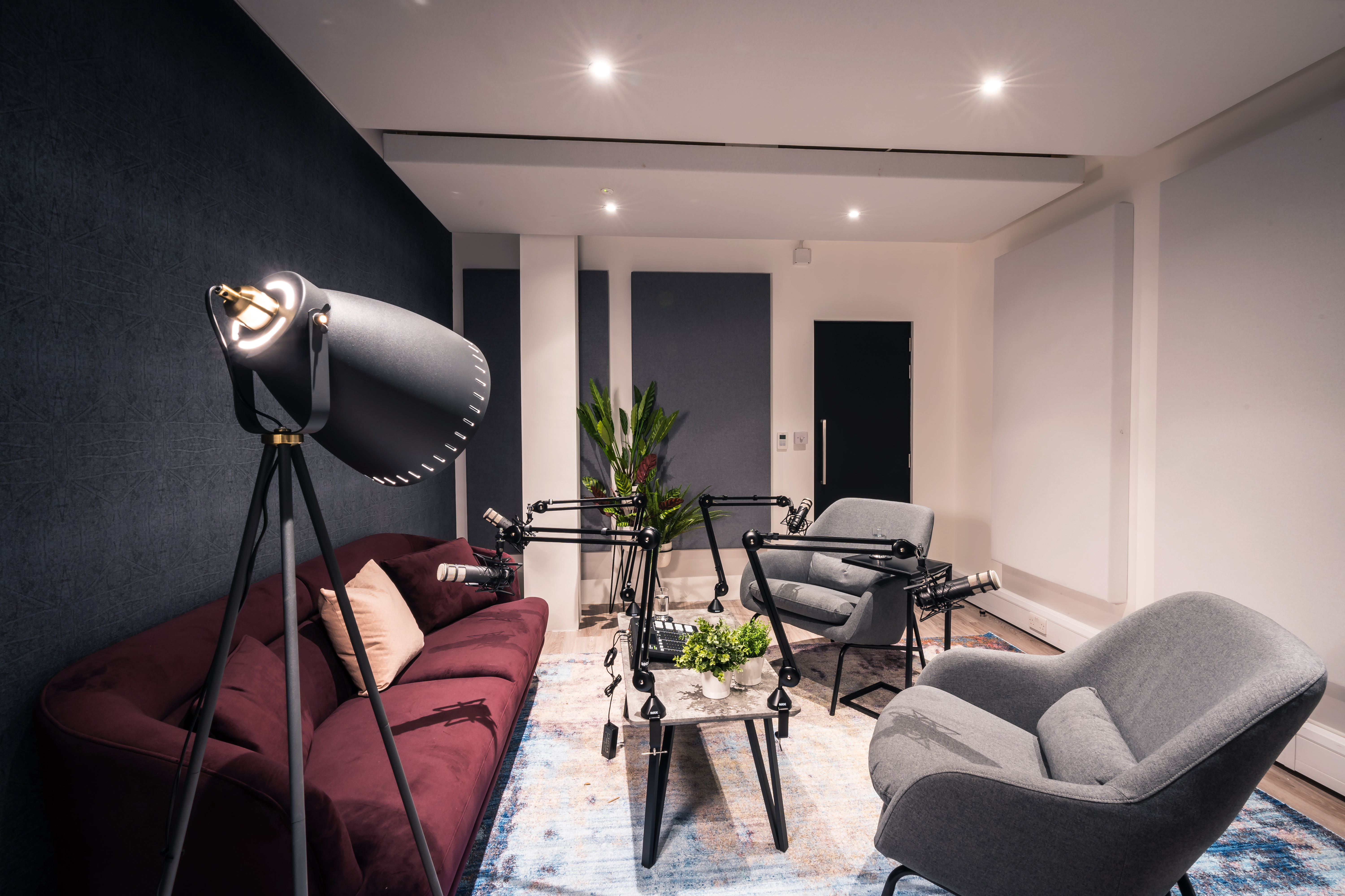 Lounge Style Podcast Room in Qube West with cozy seating for intimate events and discussions.