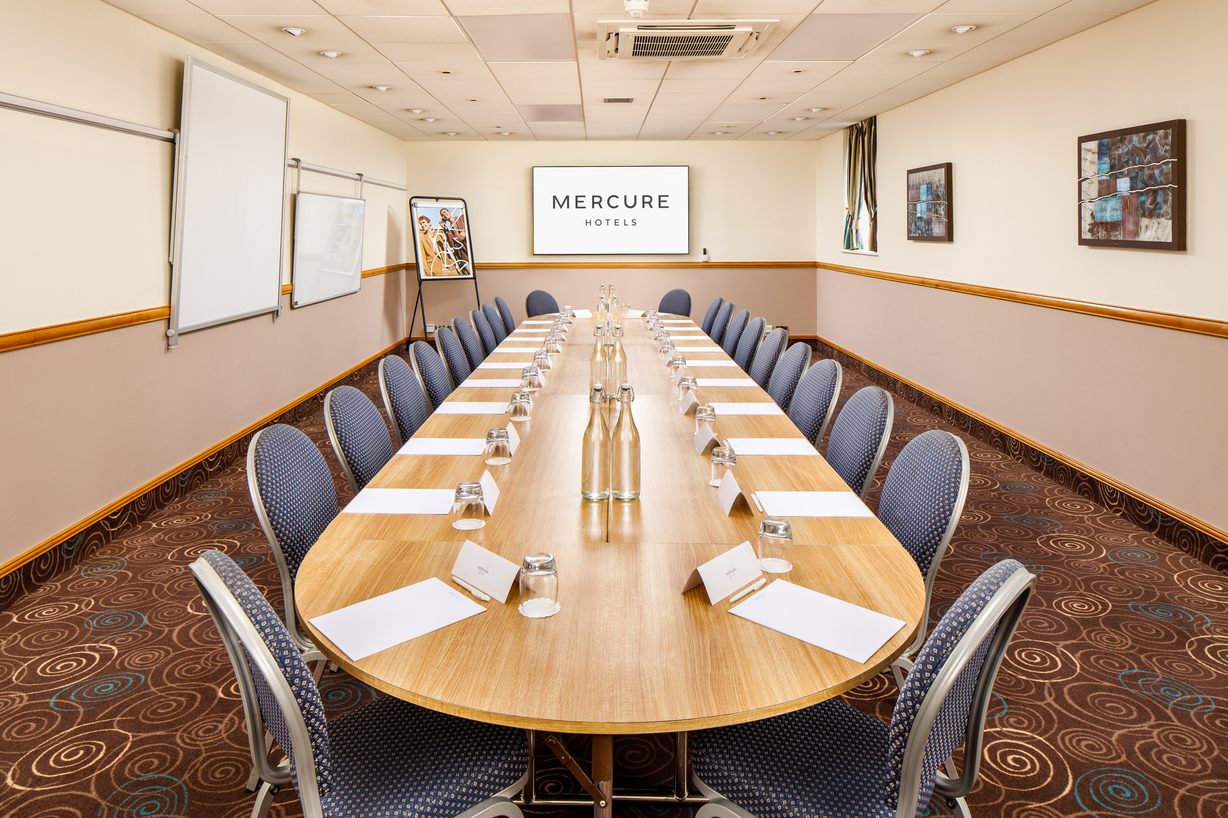 Boardroom setup in The Broker Suite, Mercure Glasgow City for team meetings and strategic workshops.