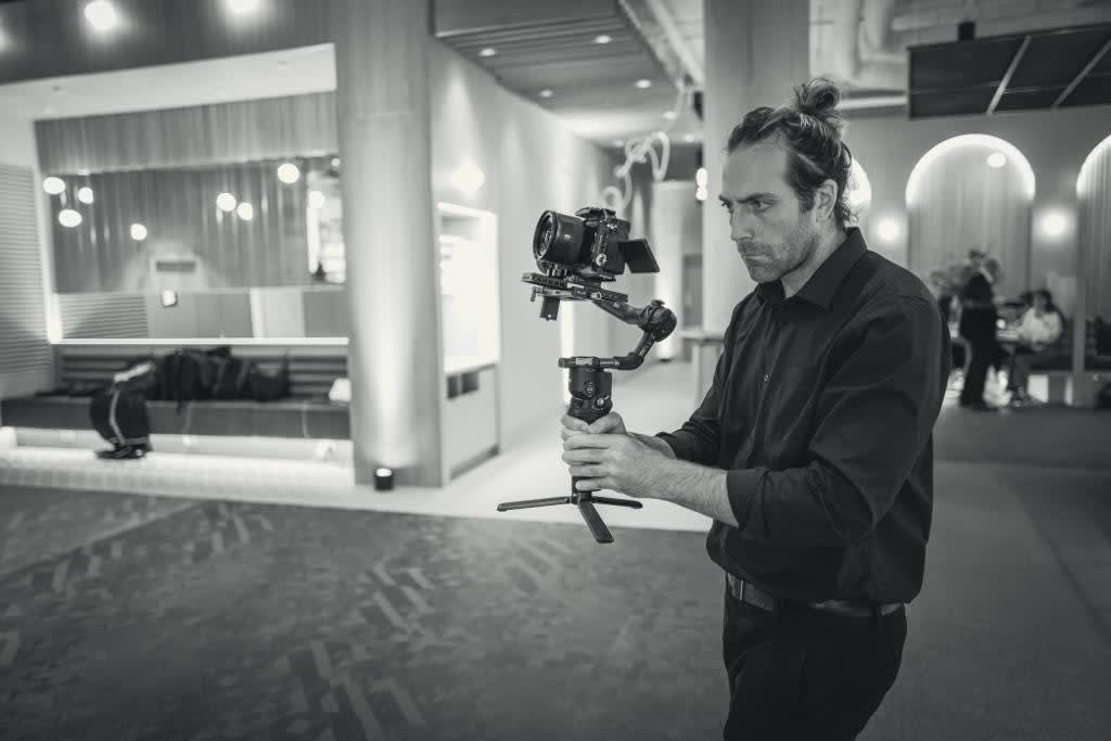 A/V professional filming event B-roll with stabilizer for marketing content production.