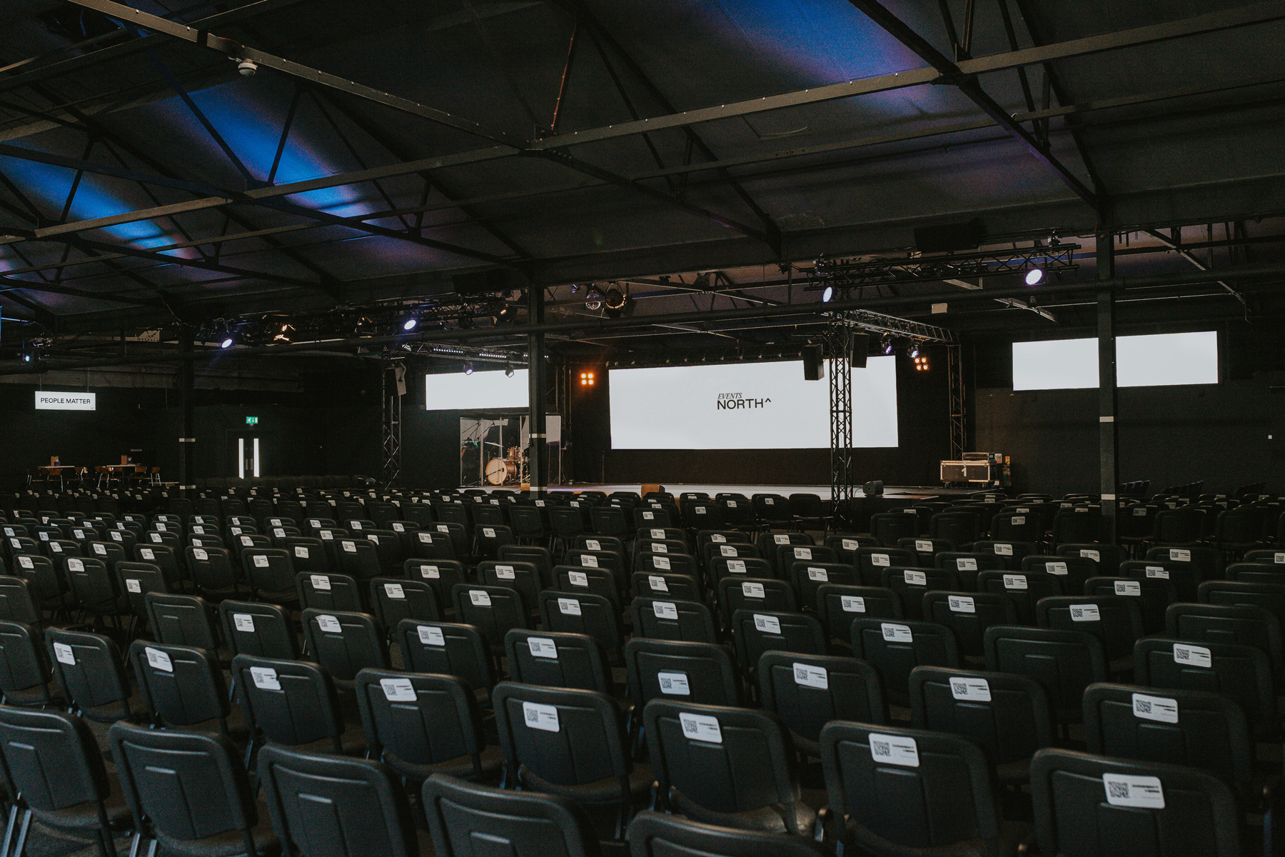 Main Auditorium at Events North: Industrial theater-style venue for corporate presentation events.