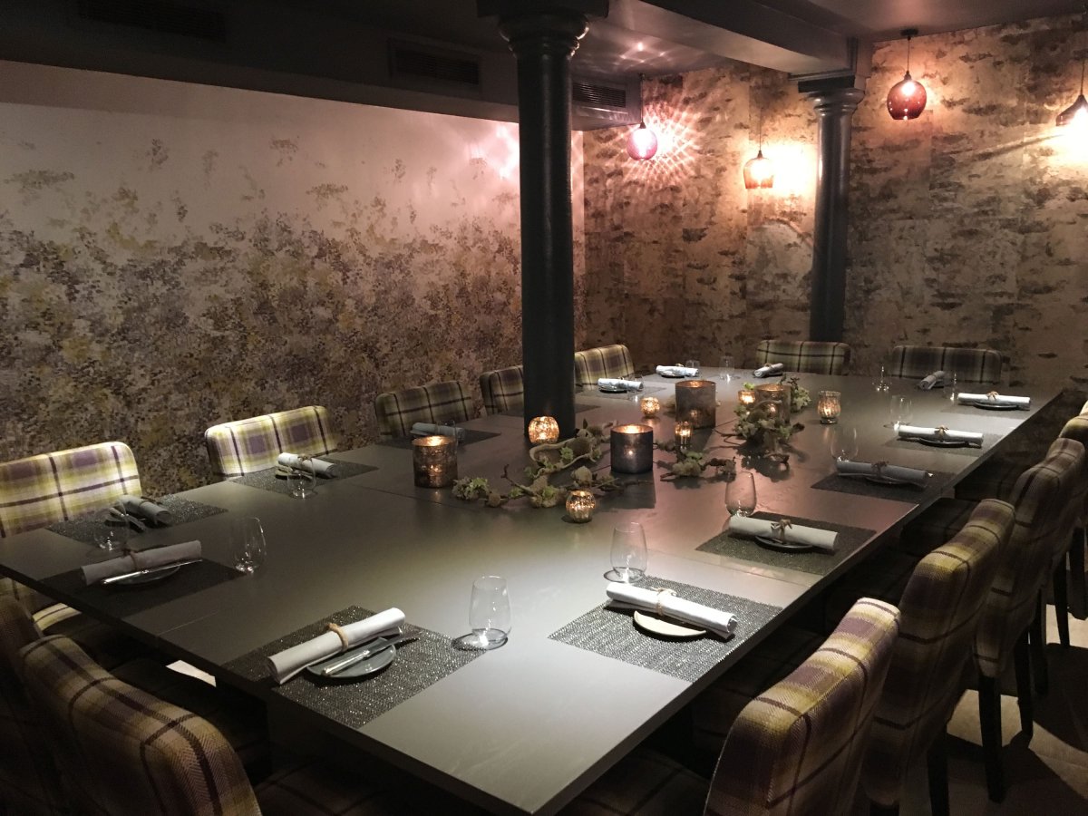 Private dining room at The Kitchin with rustic stone walls for corporate dinners and VIP meetings.