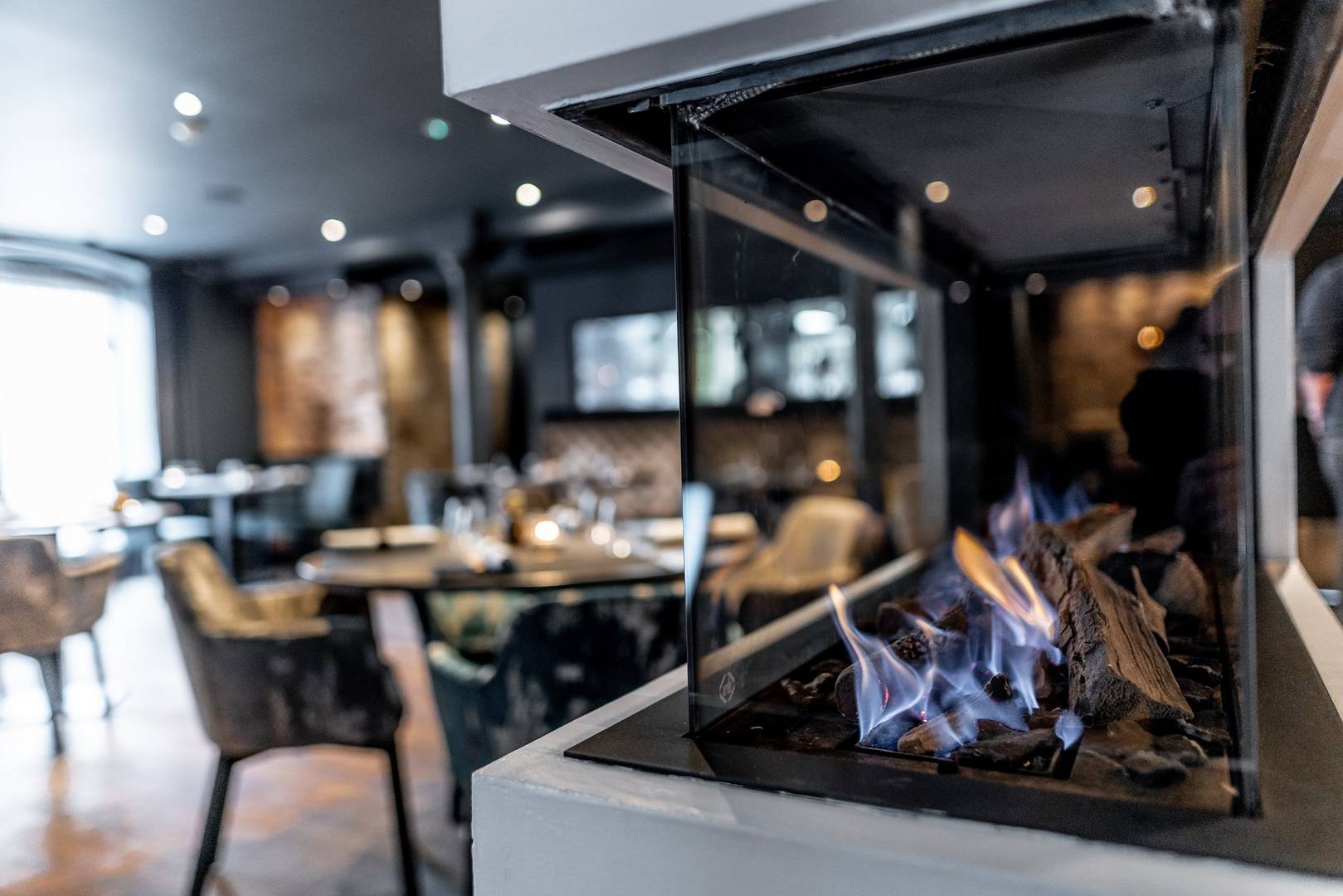 The Kitchin restaurant interior with ambient fireplace lighting for VIP dinners and events.