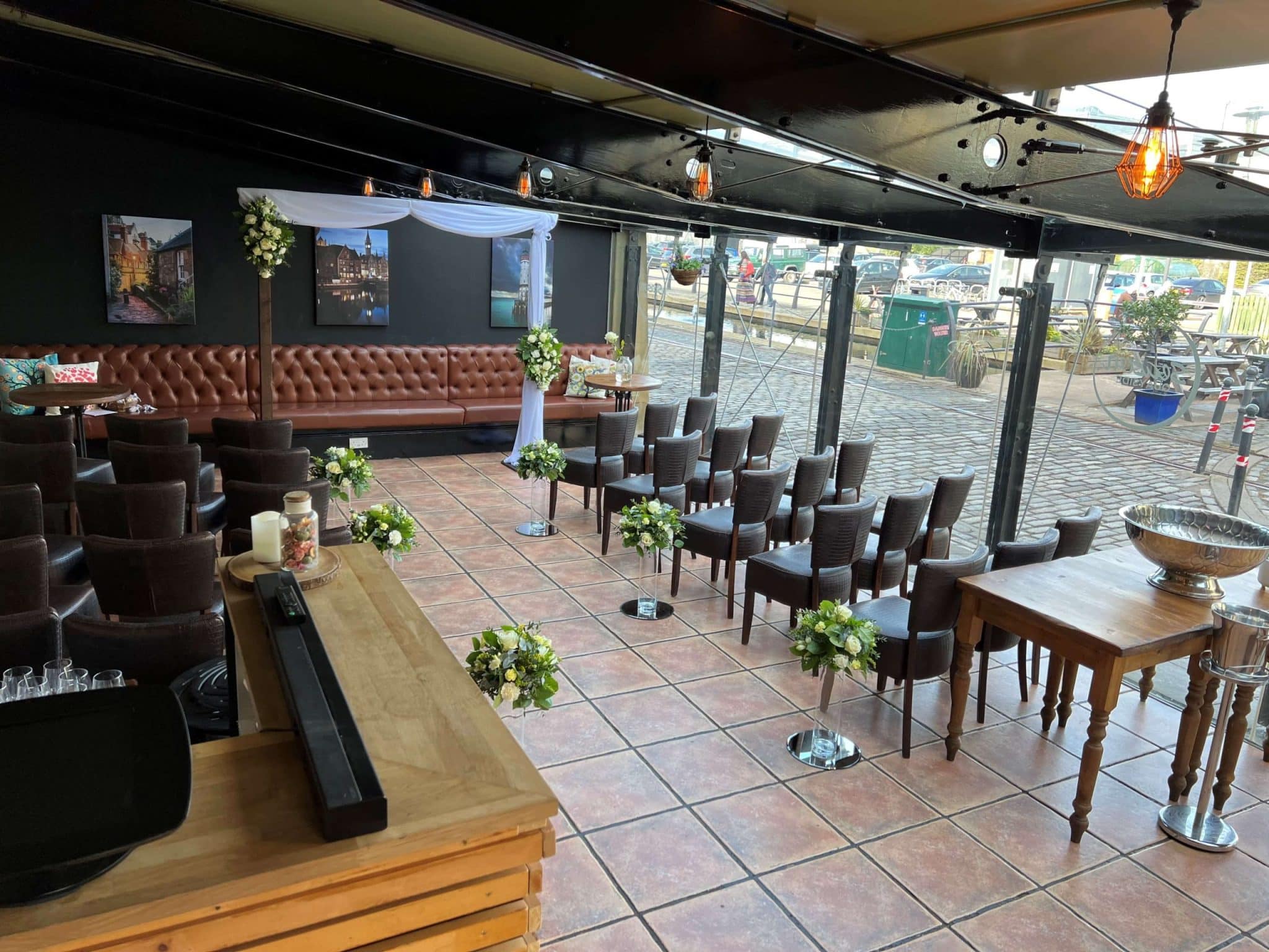 Rustic-chic Season Quayside event space with leather banquette seating for ceremonies and meetings.