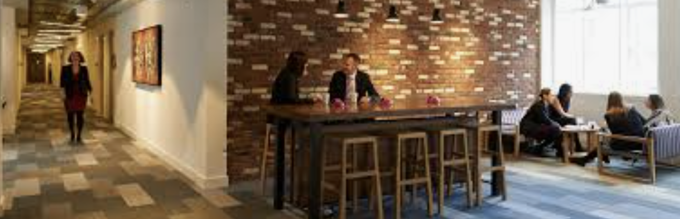 Modern meeting space at etc.venues Marble Arch with brick wall, ideal for collaboration.