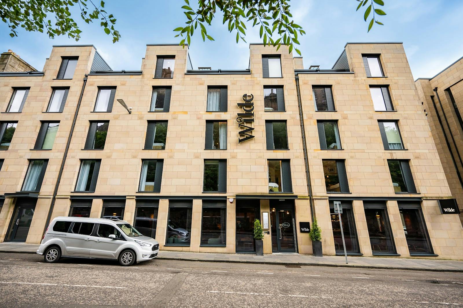 Wilde Aparthotels Edinburgh stone facade: upscale executive retreat and board meeting venue.
